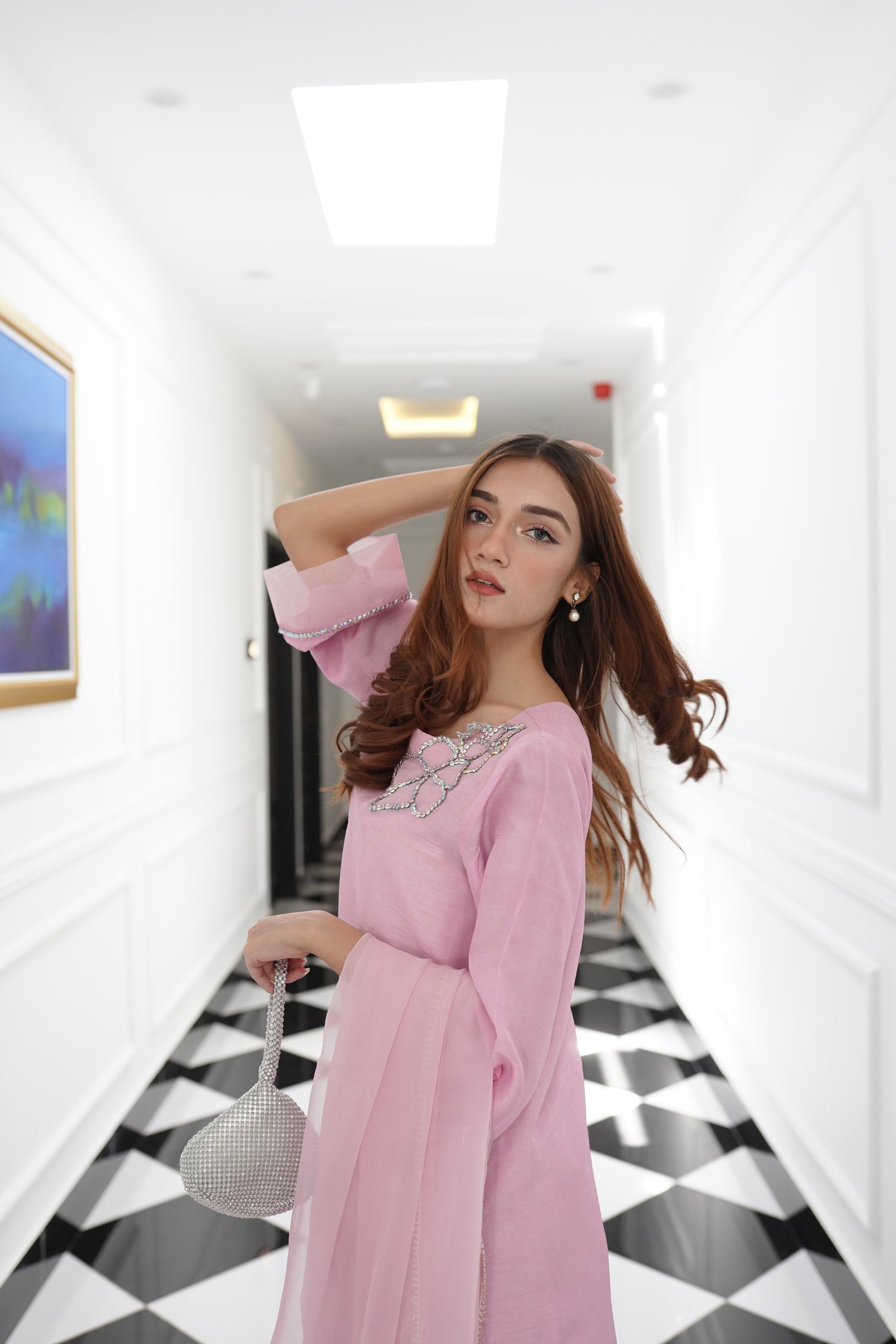 A sophisticated light pink dress with floral rhinestones showcasing style and elegance.