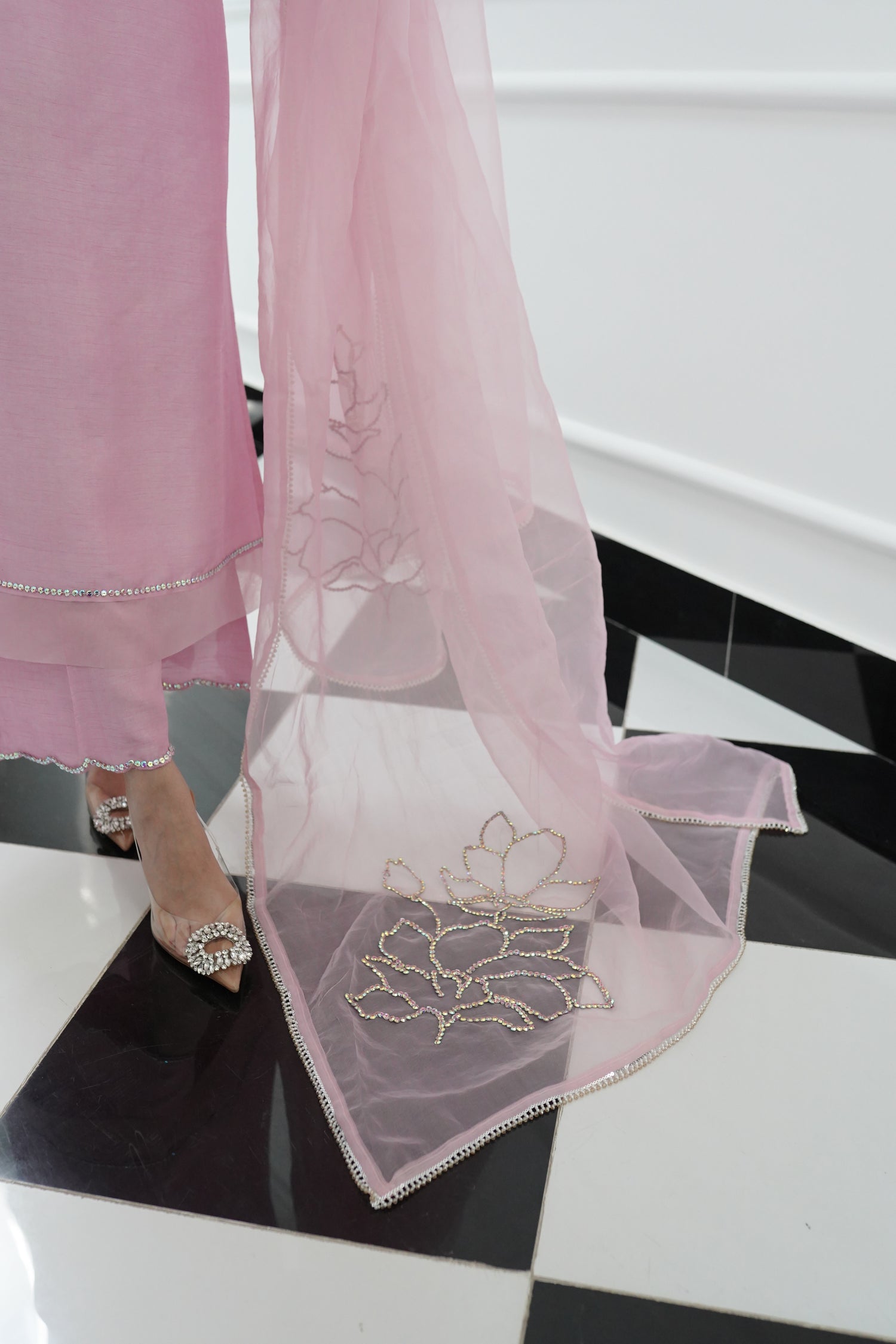 A sophisticated light pink dress with floral rhinestones showcasing style and elegance.