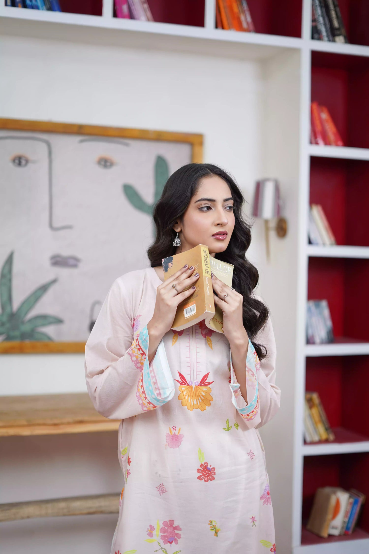 A cream-toned ensemble adorned with pastel florals and delicate neckline detailing.