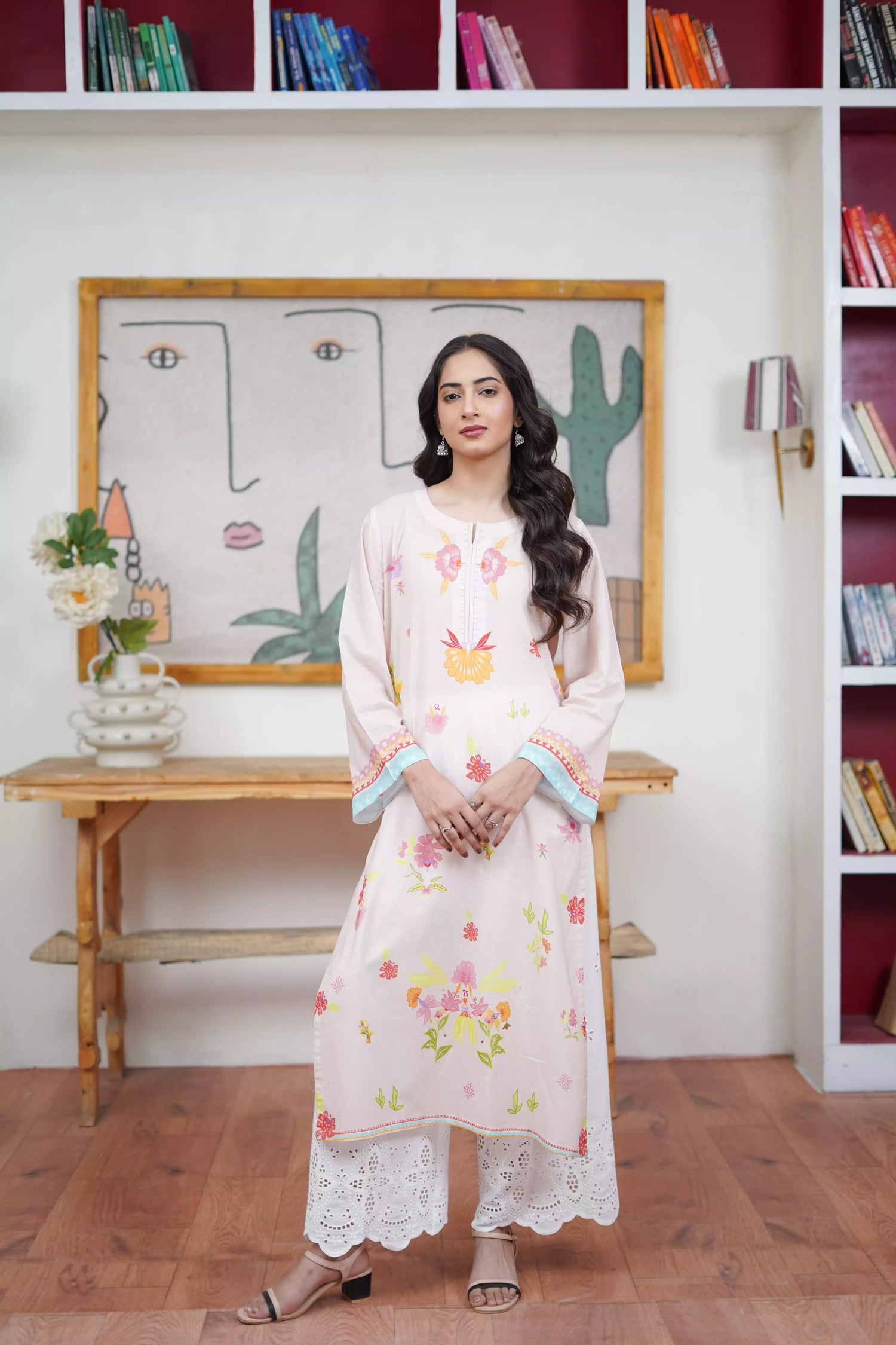 A cream-toned ensemble adorned with pastel florals and delicate neckline detailing.