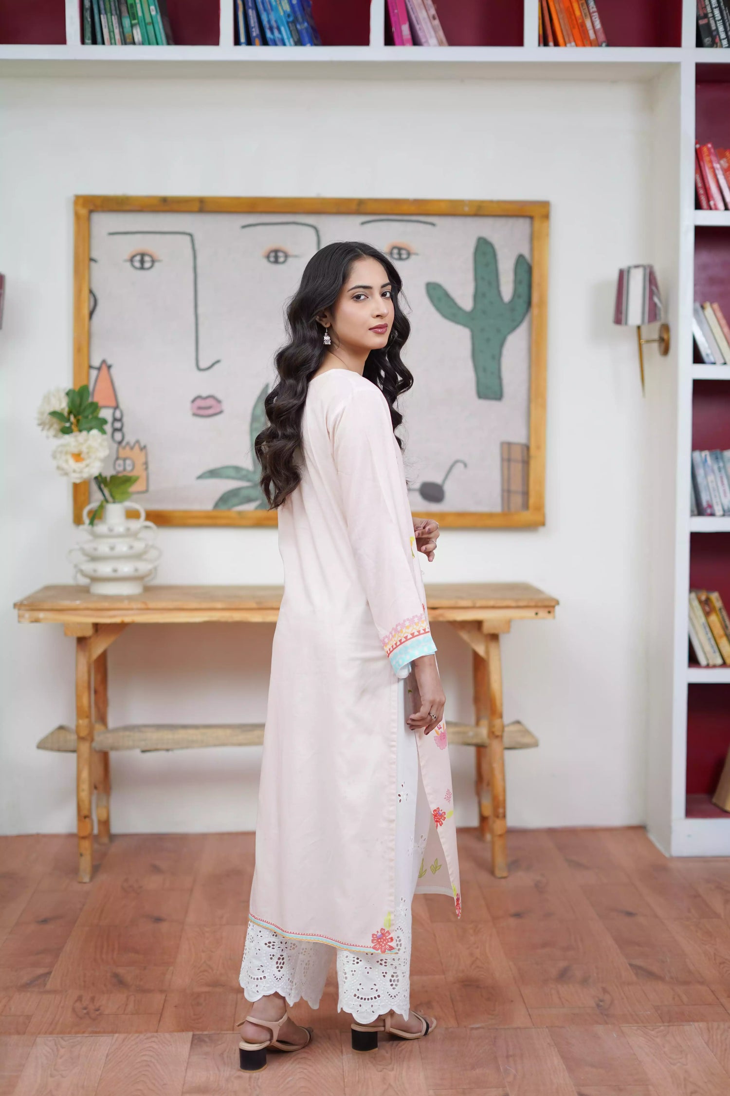 A cream-toned ensemble adorned with pastel florals and delicate neckline detailing.