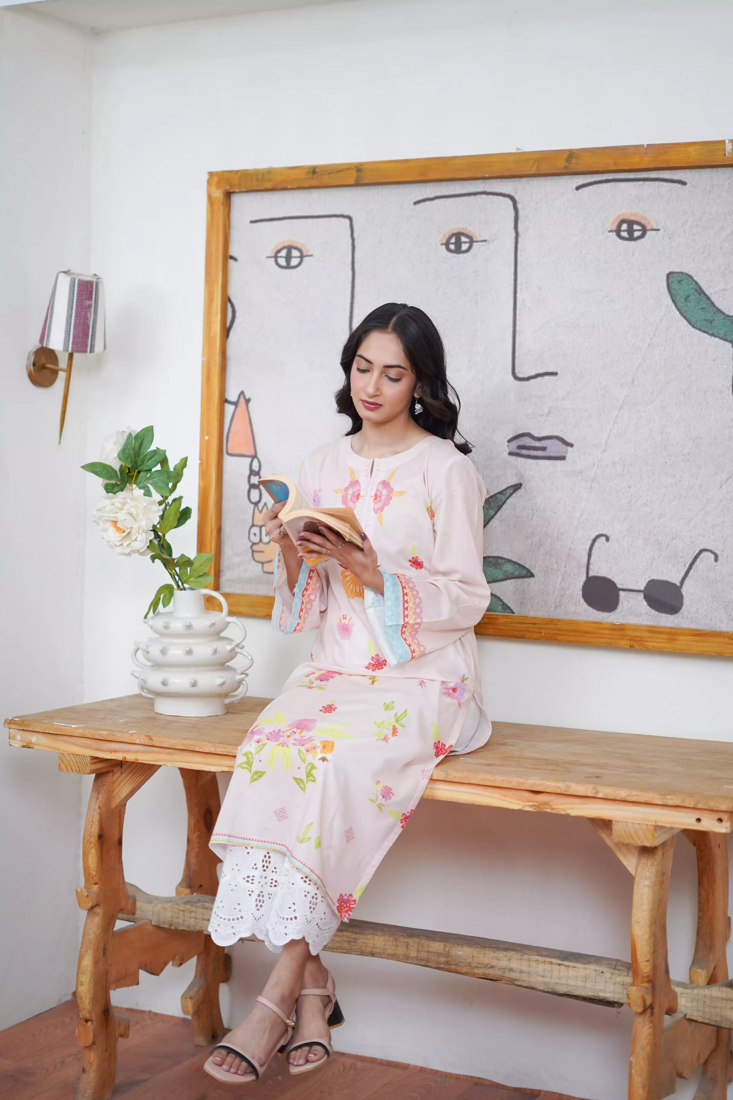 A cream-toned ensemble adorned with pastel florals and delicate neckline detailing.