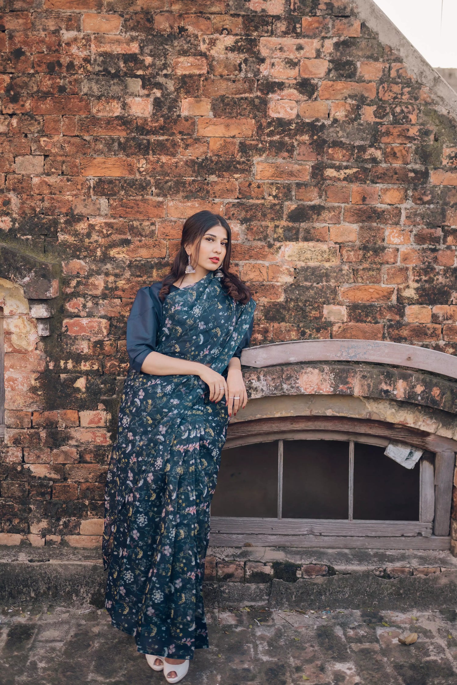 Floral navy blue saree styled gracefully with ethnic elegance.