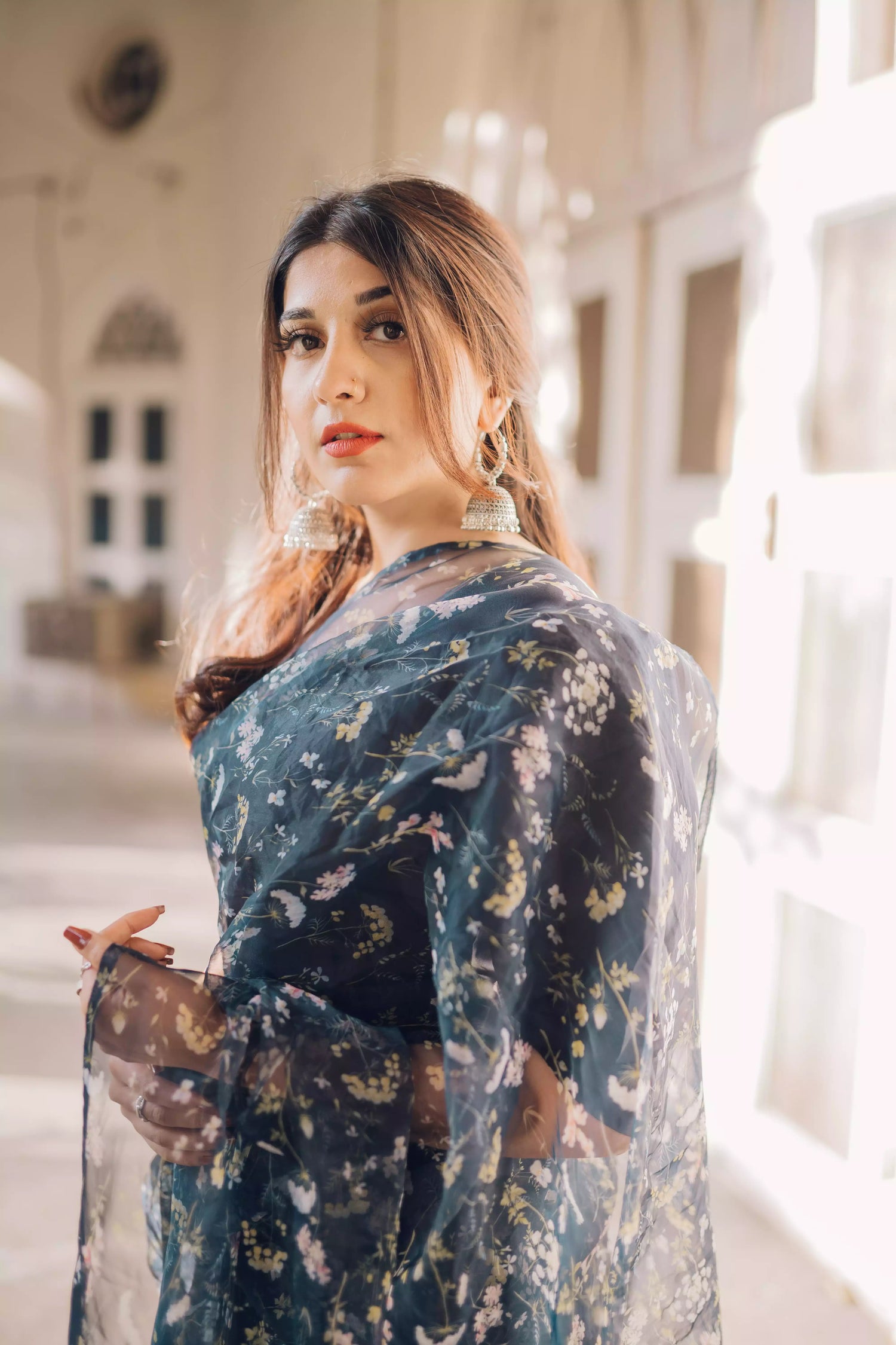 Floral navy blue saree styled gracefully with ethnic elegance.