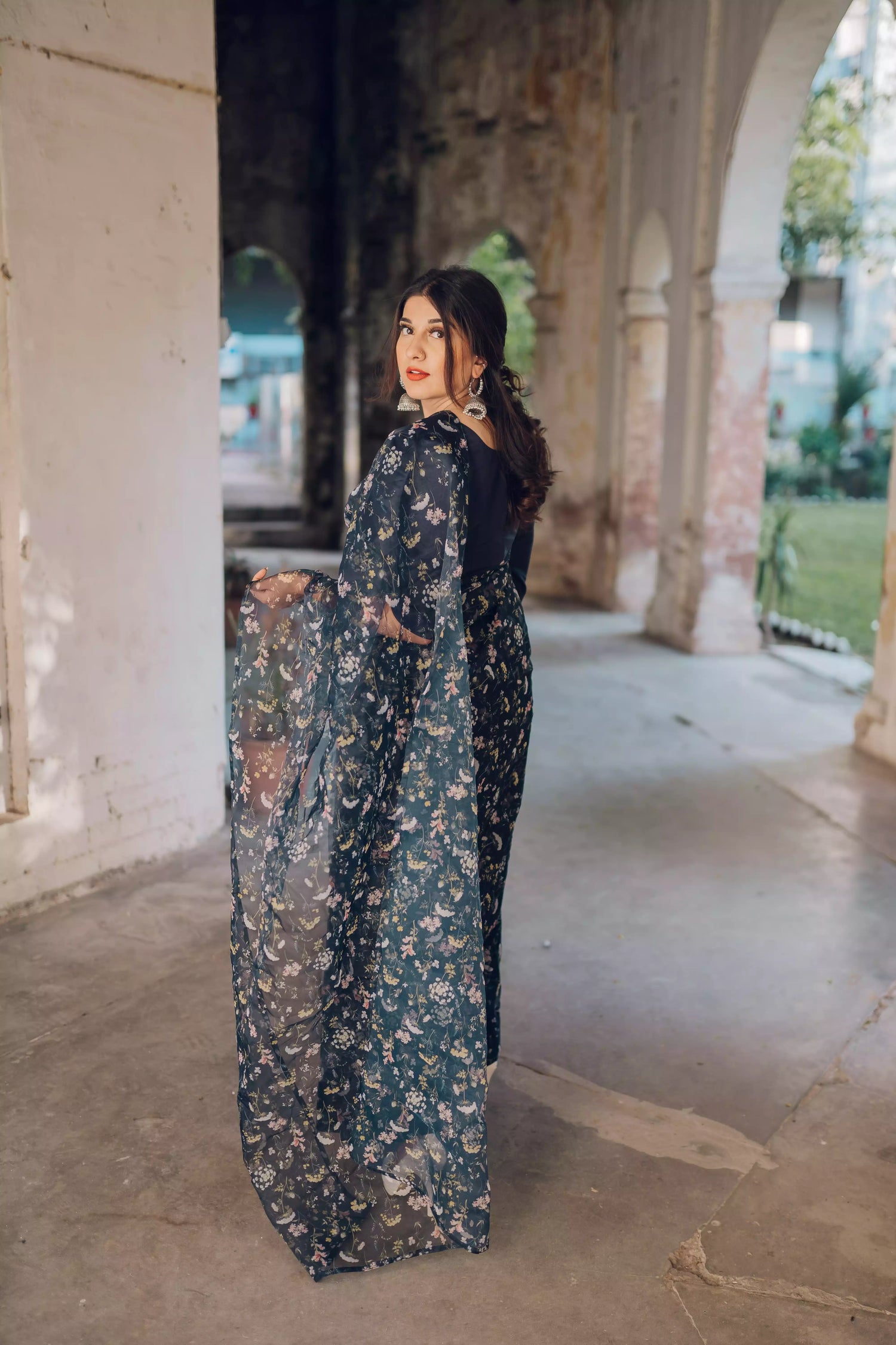 Floral navy blue saree styled gracefully with ethnic elegance.