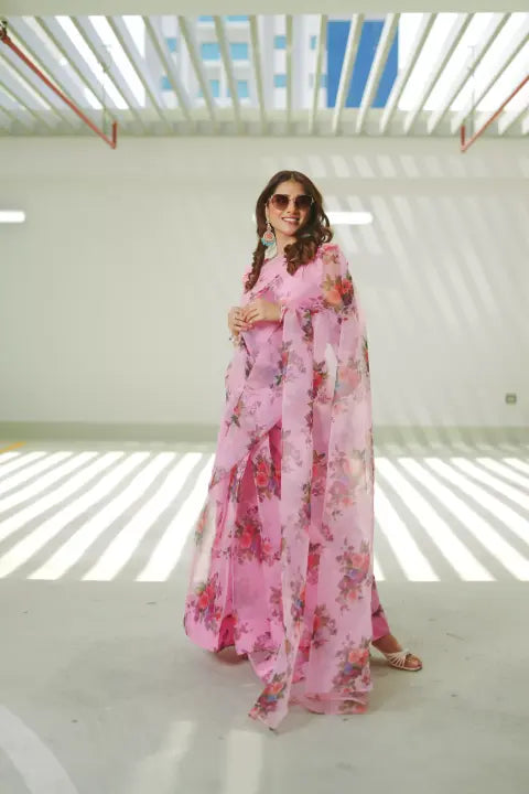 Pink floral print saree made of lightweight organza, paired with a matching Katan Silk blouse and petticoat. Perfect for festive occasions.