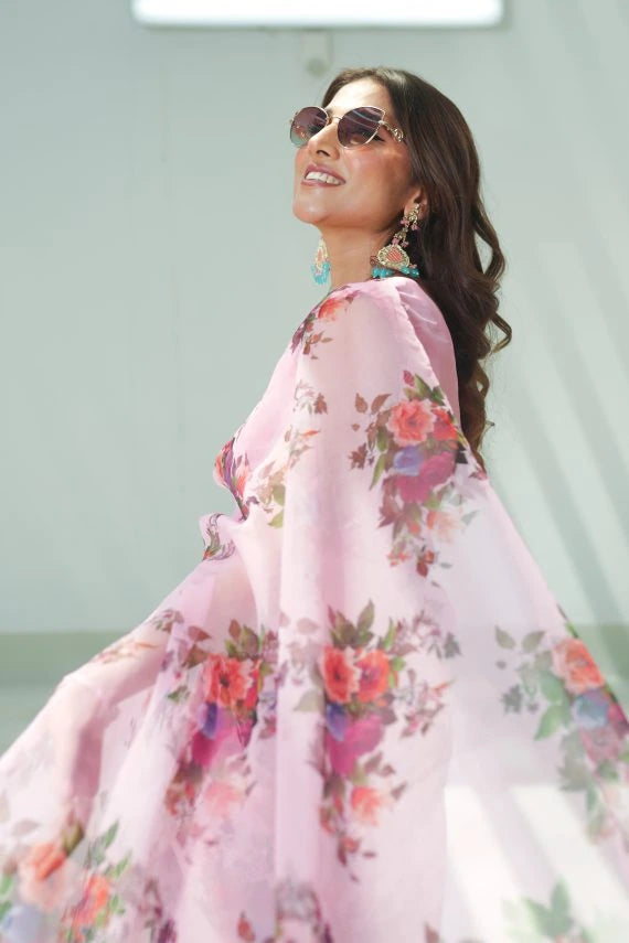 Pink floral print saree made of lightweight organza, paired with a matching Katan Silk blouse and petticoat. Perfect for festive occasions.