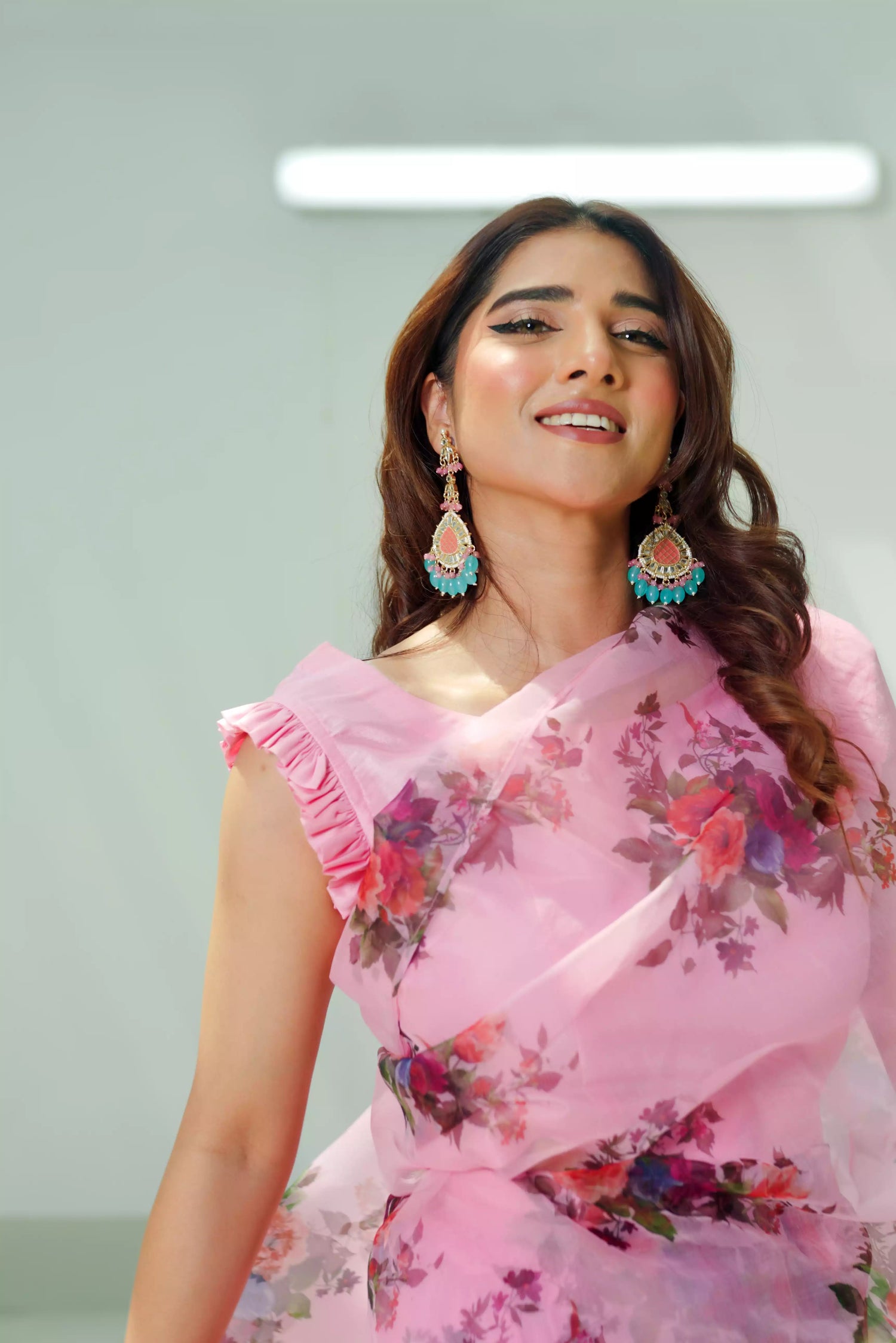 Pink floral print saree made of lightweight organza, paired with a matching Katan Silk blouse and petticoat. Perfect for festive occasions.