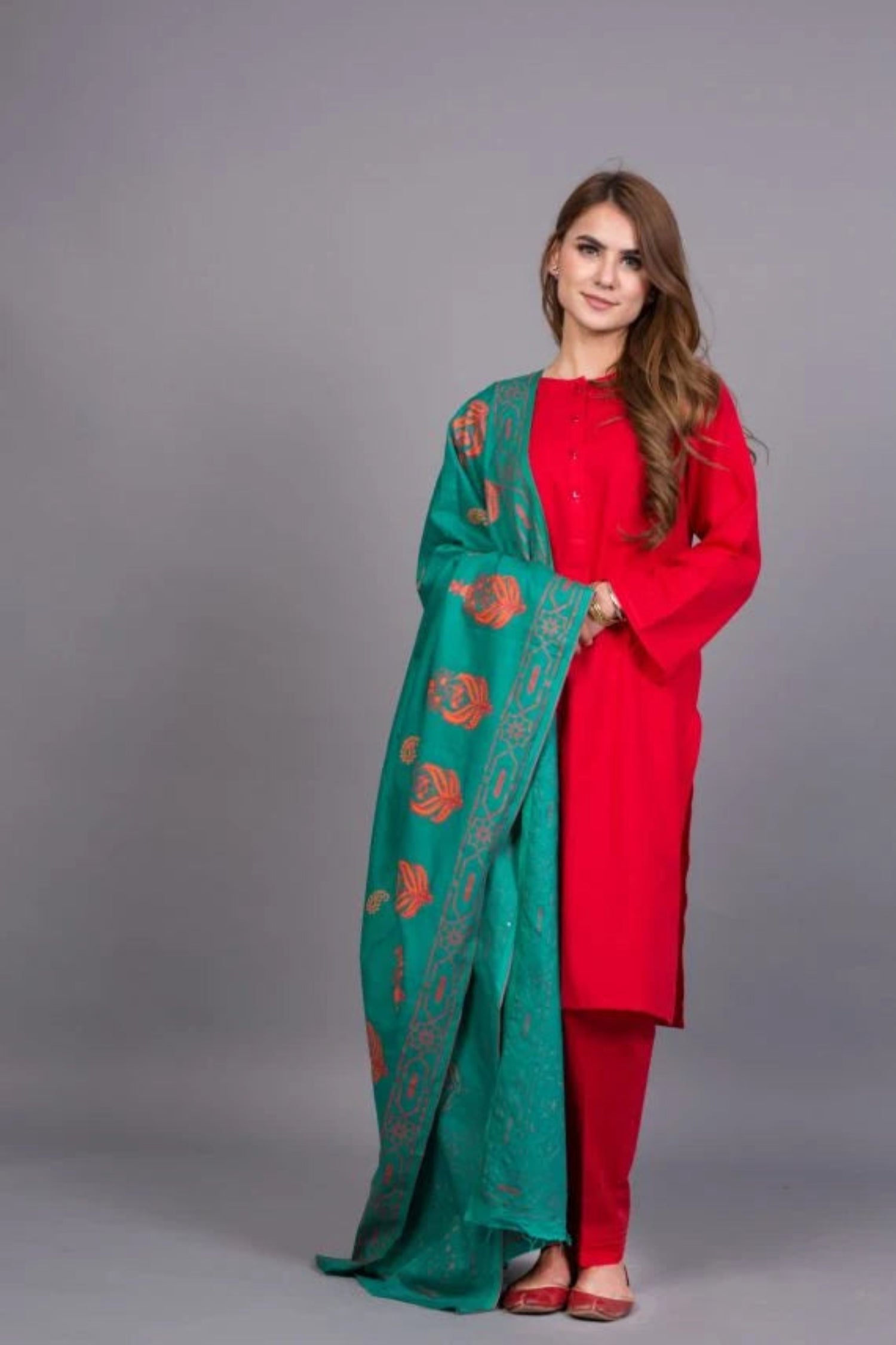 A stunning teal shawl featuring red and orange block printed motifs, crafted from soft and breathable Swiss Khadar fabric, perfect for semi-formal or formal events.