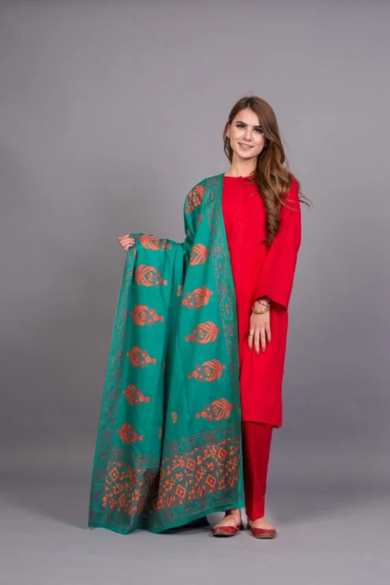 A stunning teal shawl featuring red and orange block printed motifs, crafted from soft and breathable Swiss Khadar fabric, perfect for semi-formal or formal events.