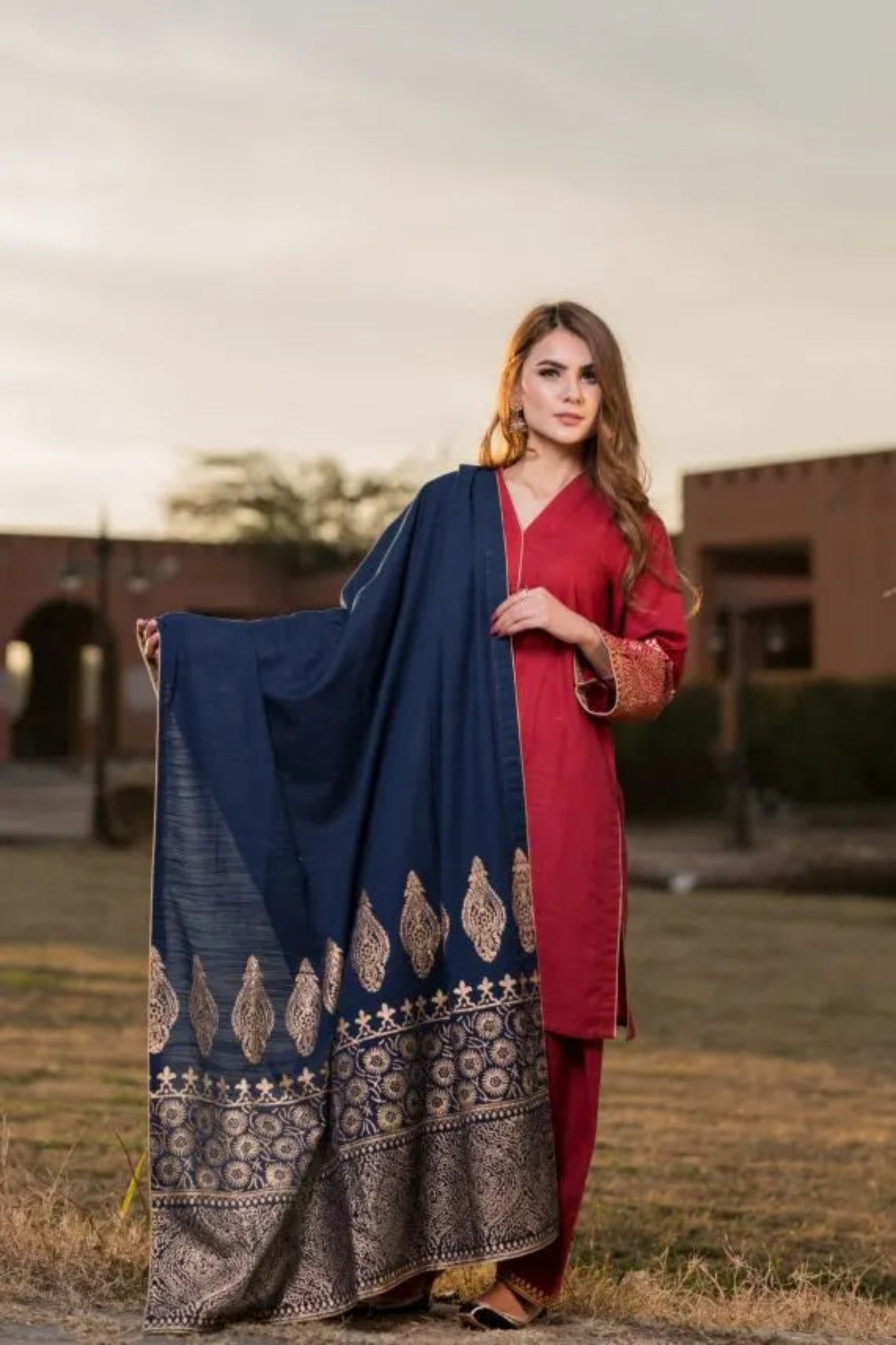 A navy blue shawl with golden block printed design adored with golden piko finishing exuding elegance and sophistication.