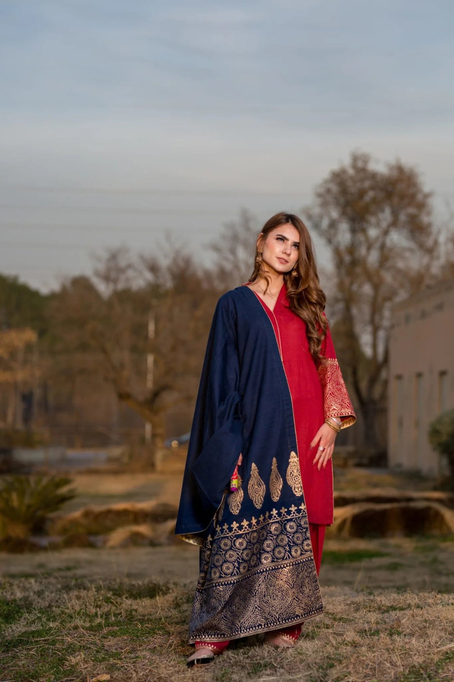 A navy blue shawl with golden block printed design adored with golden piko finishing exuding elegance and sophistication.