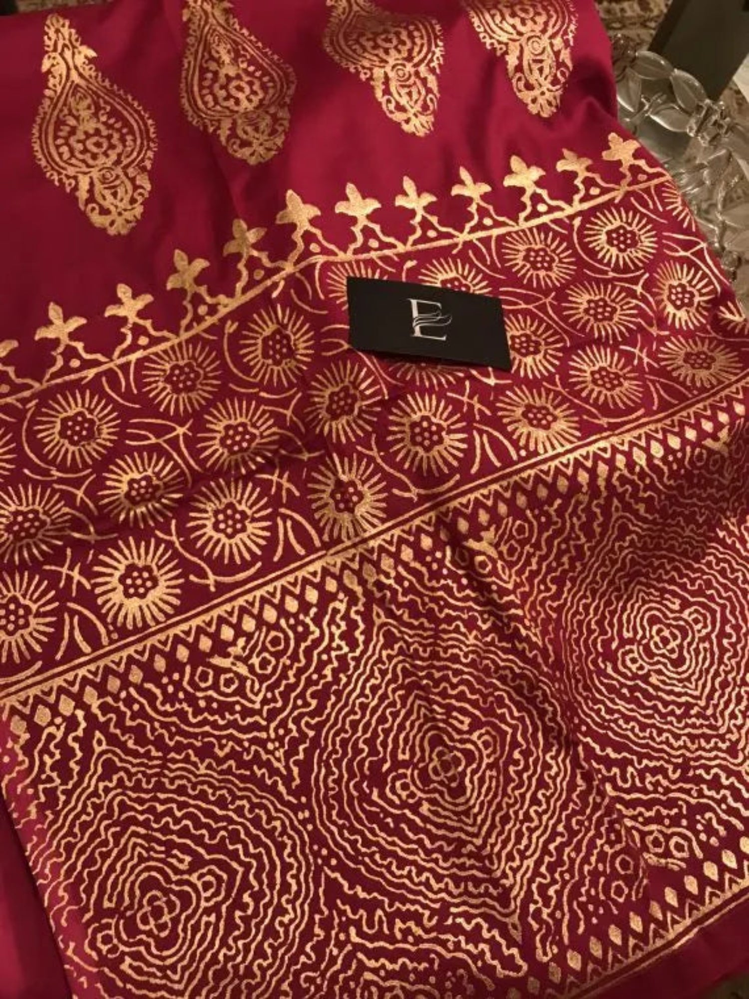 A navy blue shawl with golden block printed design adored with golden piko finishing exuding elegance and sophistication.
