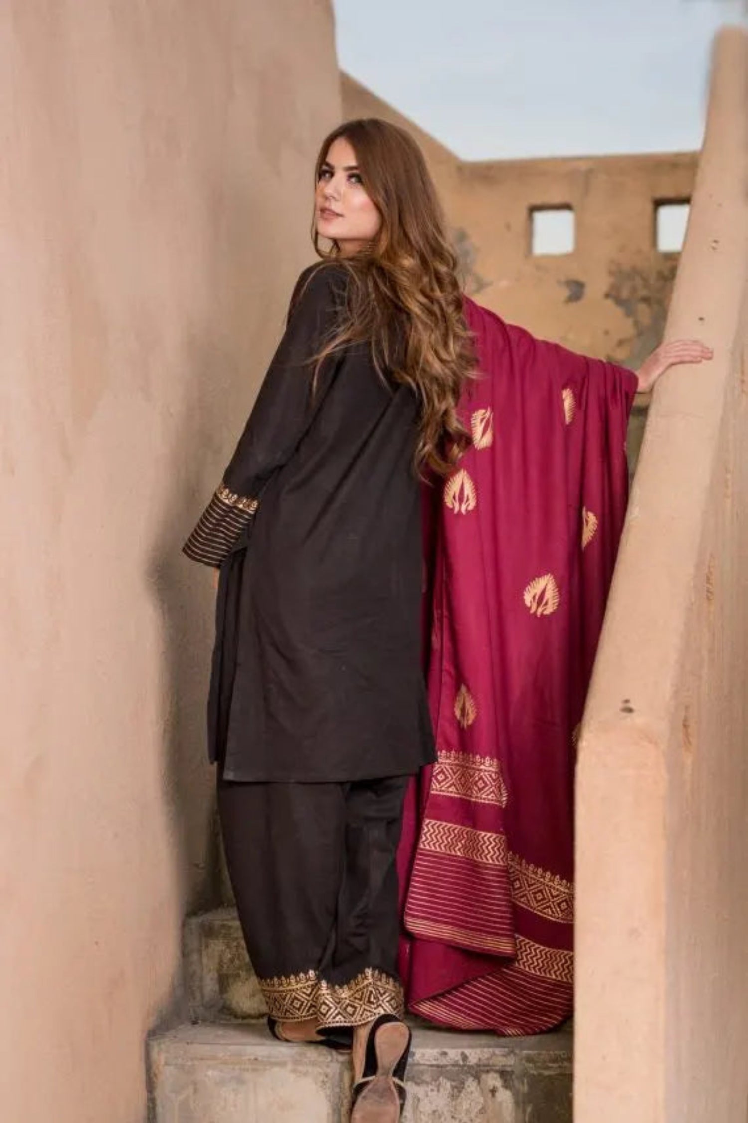 A sophisticated Nakash Maroon Gold Shawl adored with block printed motifs and border, highlighting the elegant and unique look.