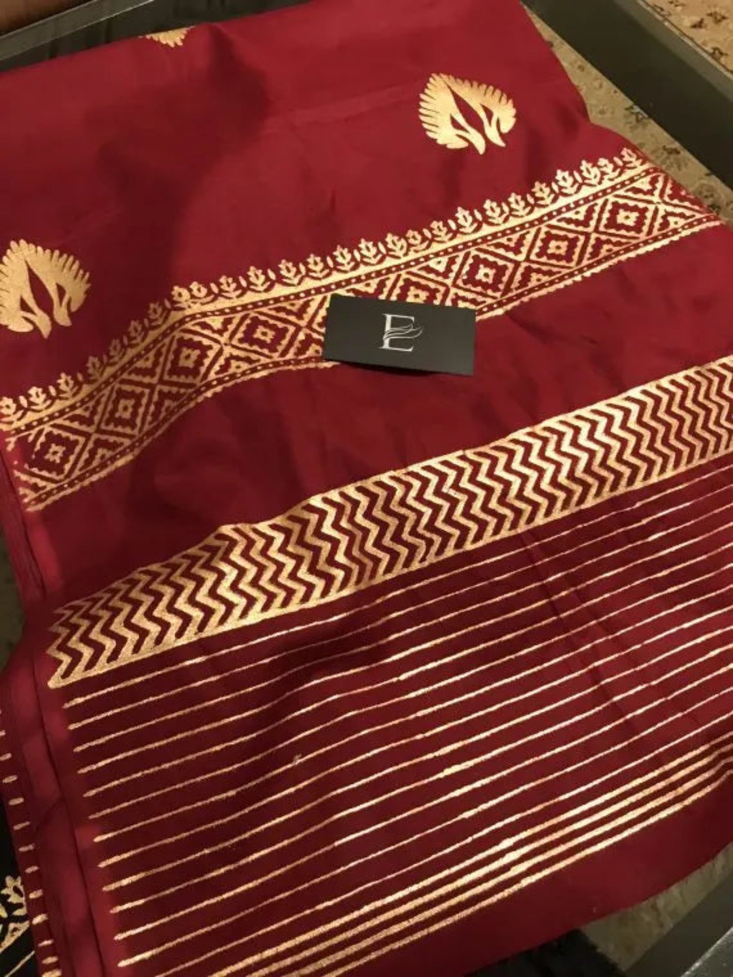 A sophisticated Nakash Maroon Gold Shawl adored with block printed motifs and border, highlighting the elegant and unique look.