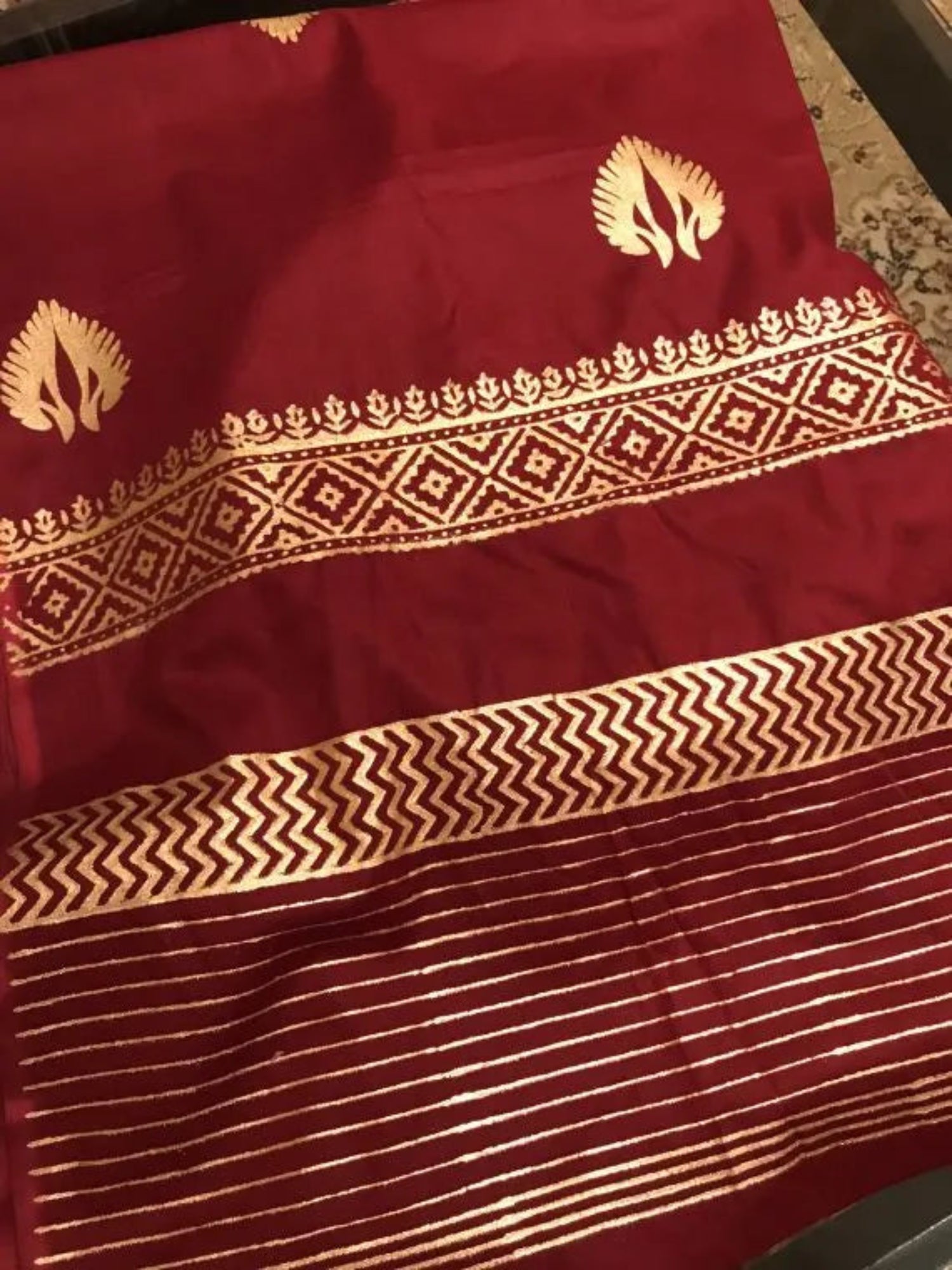 A sophisticated Nakash Maroon Gold Shawl adored with block printed motifs and border, highlighting the elegant and unique look.