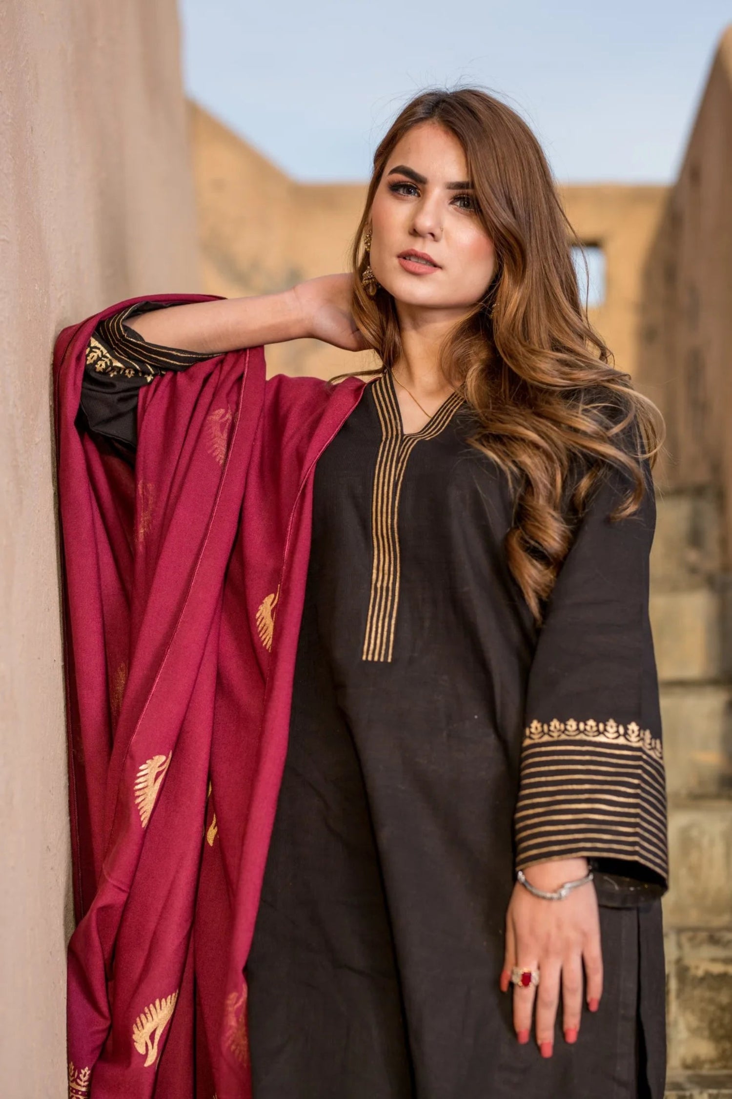 A sophisticated Nakash Maroon Gold Shawl adored with block printed motifs and border, highlighting the elegant and unique look.