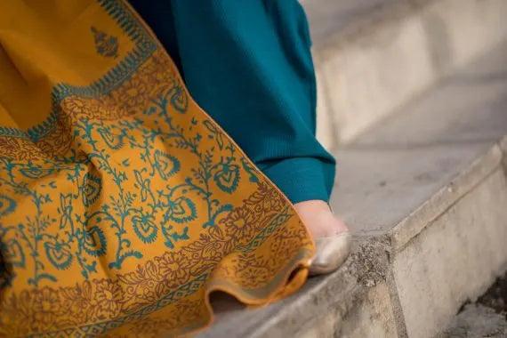 Elegant and trendy mustard swiss khaddar shawl adored with artisan block print patterns on the border as well as small motifs scattered throughout the shawl, perfect for casual and festive wear.