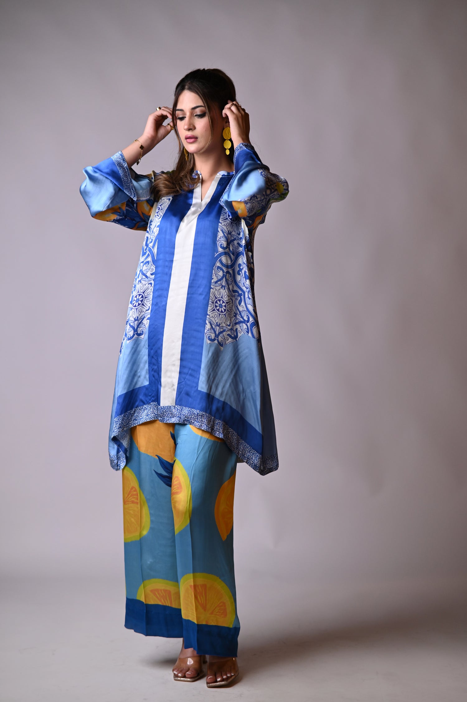 A blue and yellow cord set patterned pants, inspired by the sunny shores and vibrant colors of Santorini.