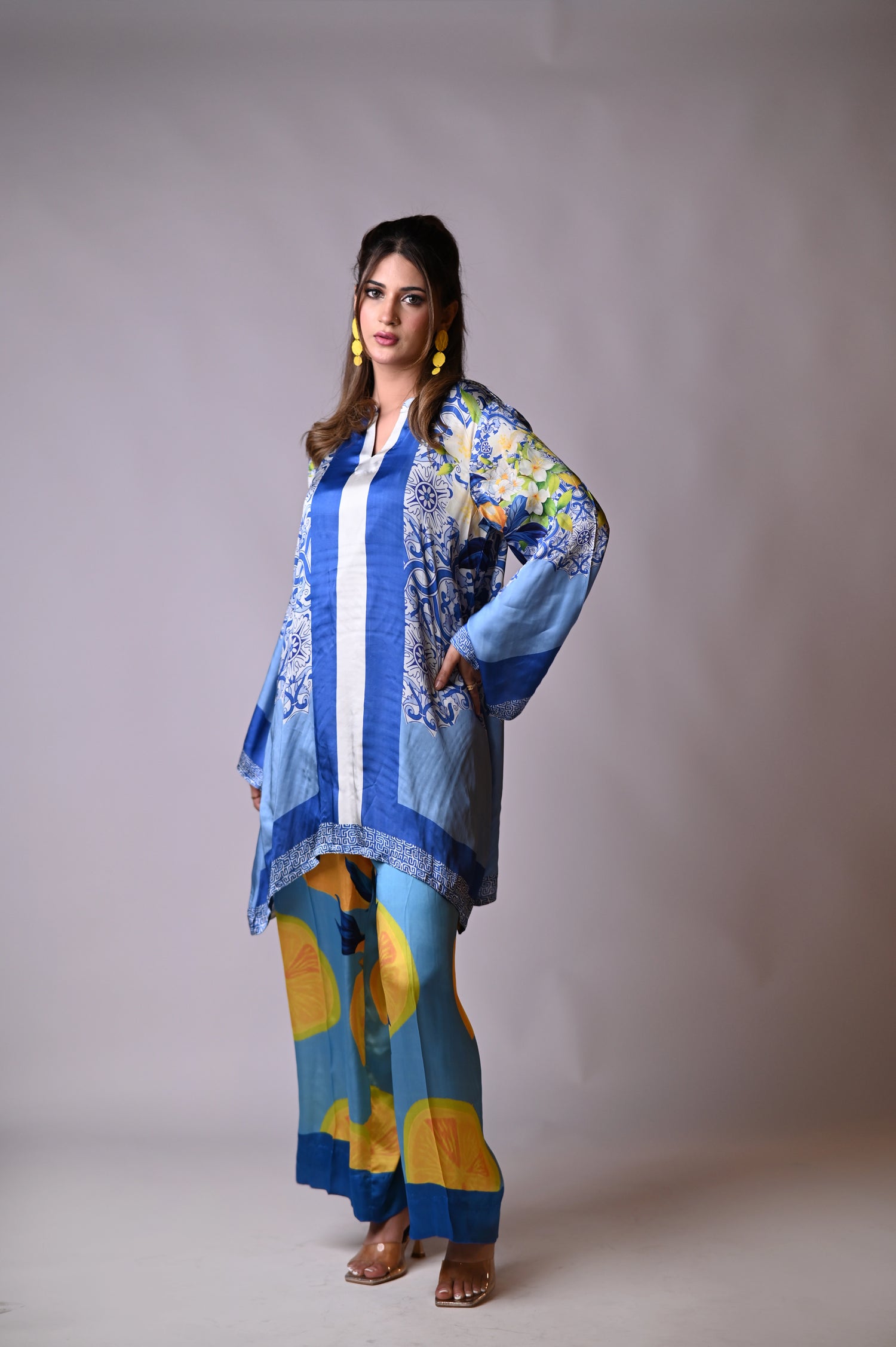A blue and yellow cord set patterned pants, inspired by the sunny shores and vibrant colors of Santorini.