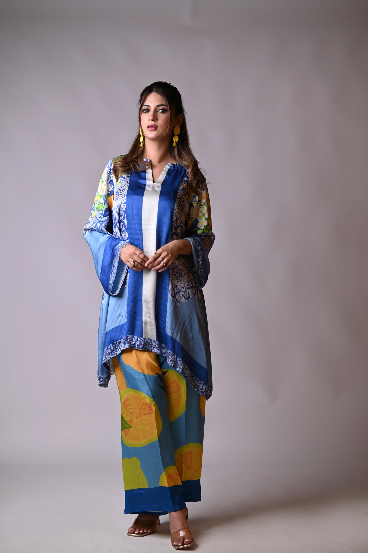 A blue and yellow cord set patterned pants, inspired by the sunny shores and vibrant colors of Santorini.