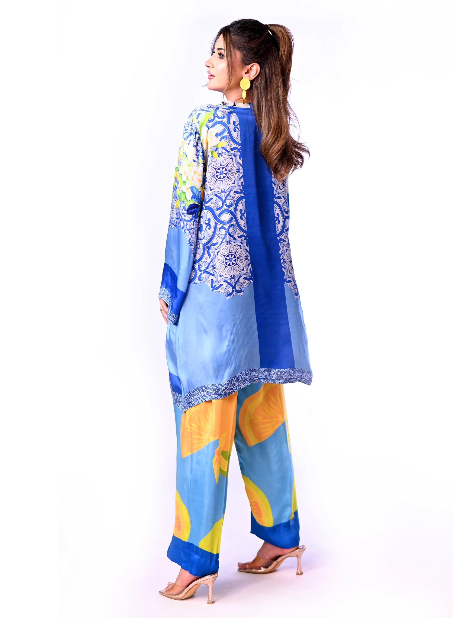 A blue and yellow cord set patterned pants, inspired by the sunny shores and vibrant colors of Santorini.
