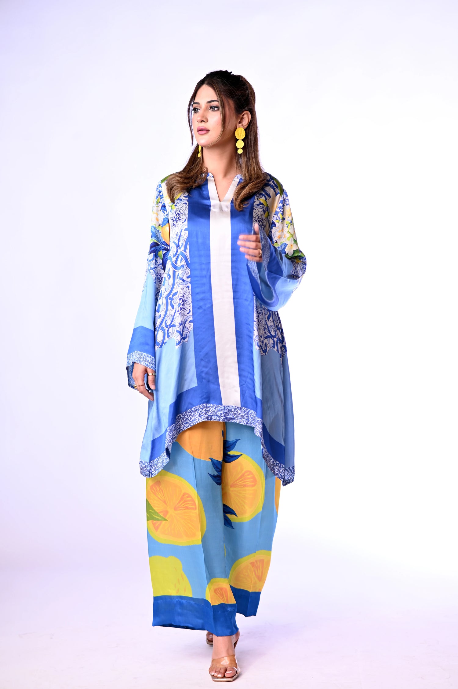 A blue and yellow cord set patterned pants, inspired by the sunny shores and vibrant colors of Santorini.