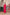 A deep red three piece suit complemented by a teal and pink floral dupatta, perfect for festive charm.