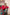 A deep red three piece suit complemented by a teal and pink floral dupatta, perfect for festive charm.