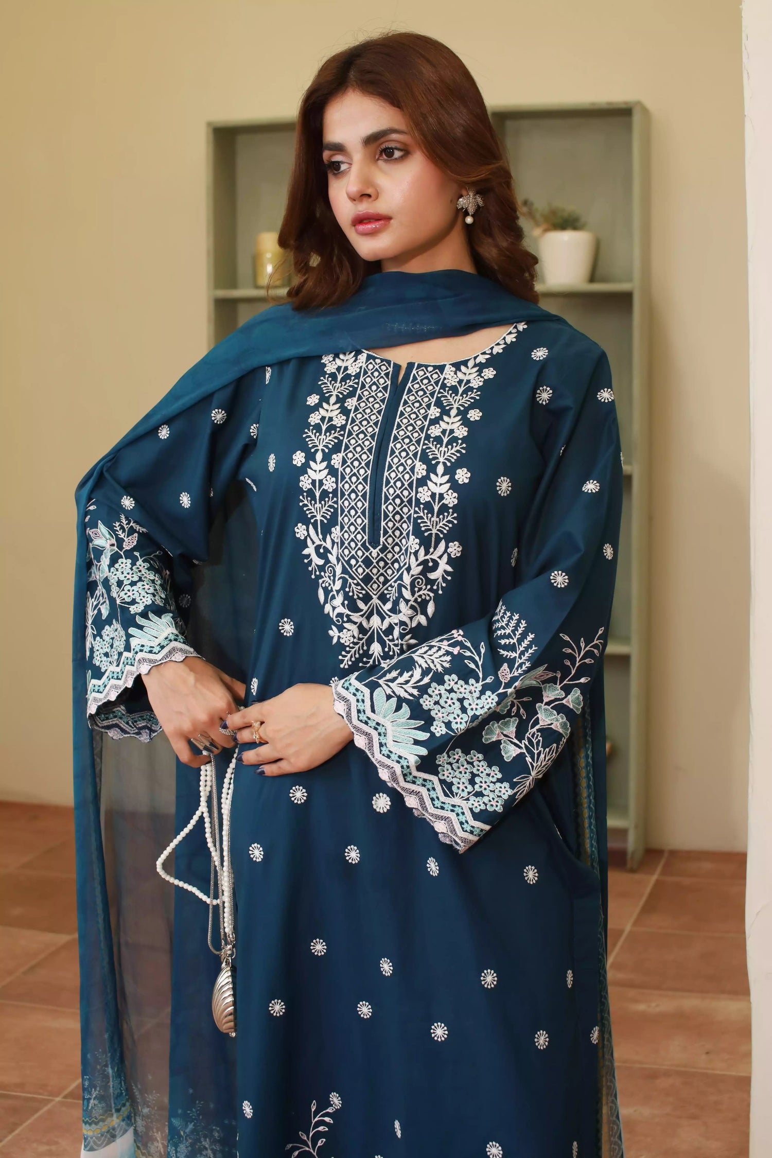 Elegant zinc blue embroidered suit featuring detailed white motifs, complemented by a chiffon dupatta.