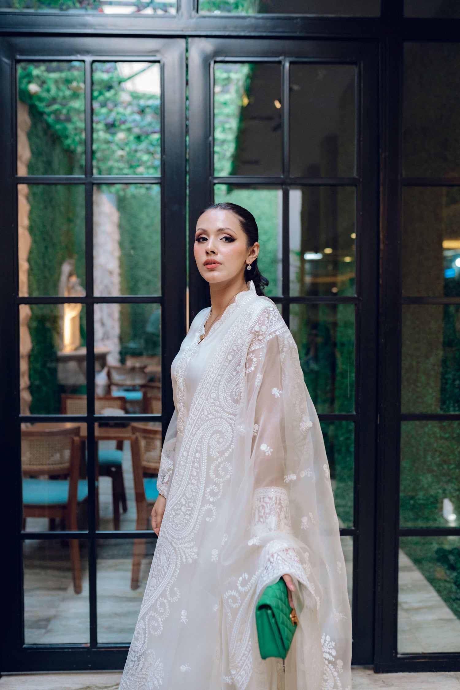 A white dress featuring intricate lace and embroidered organza, exuding elegance and sophistication.