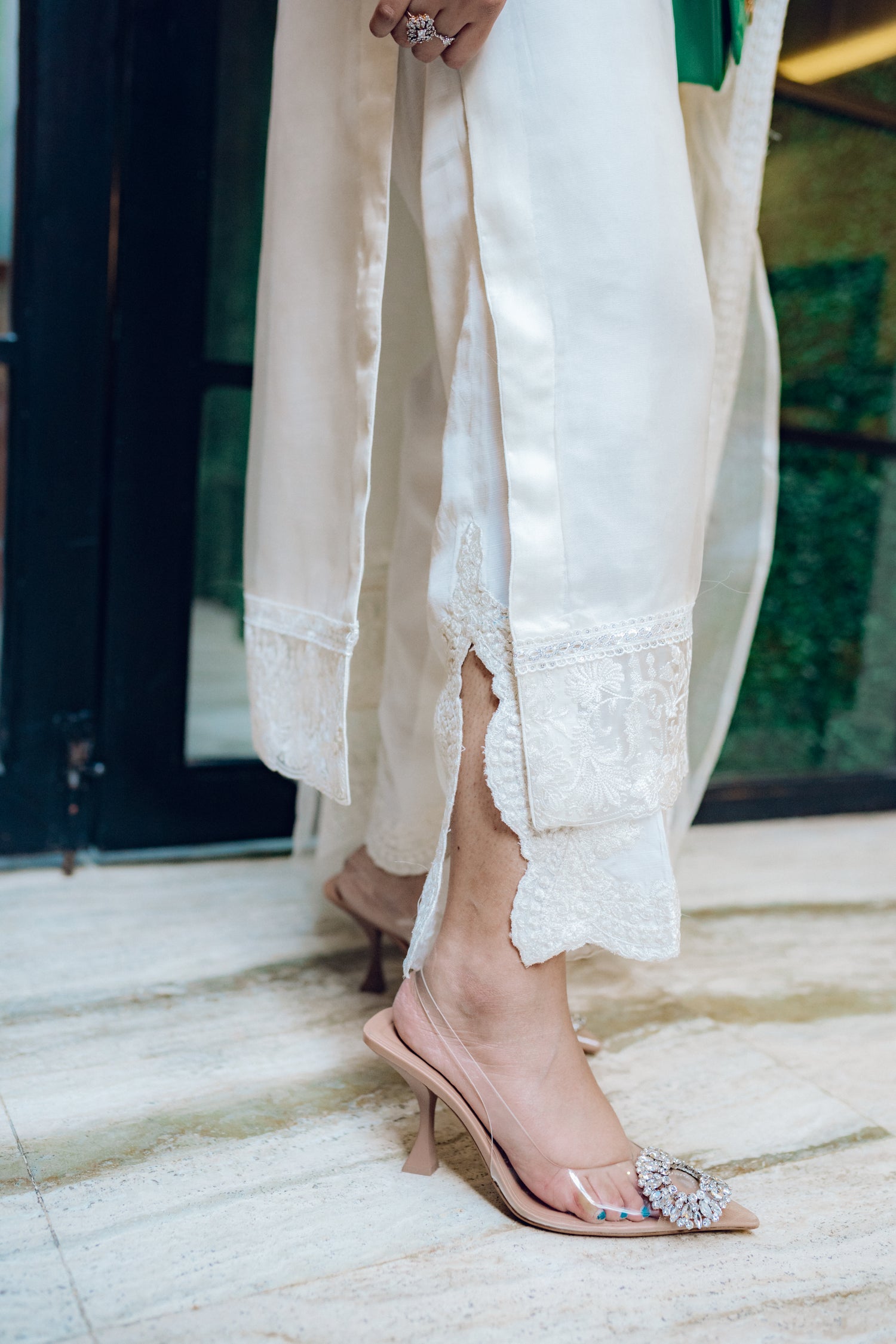 A white dress featuring intricate lace and embroidered organza, exuding elegance and sophistication.