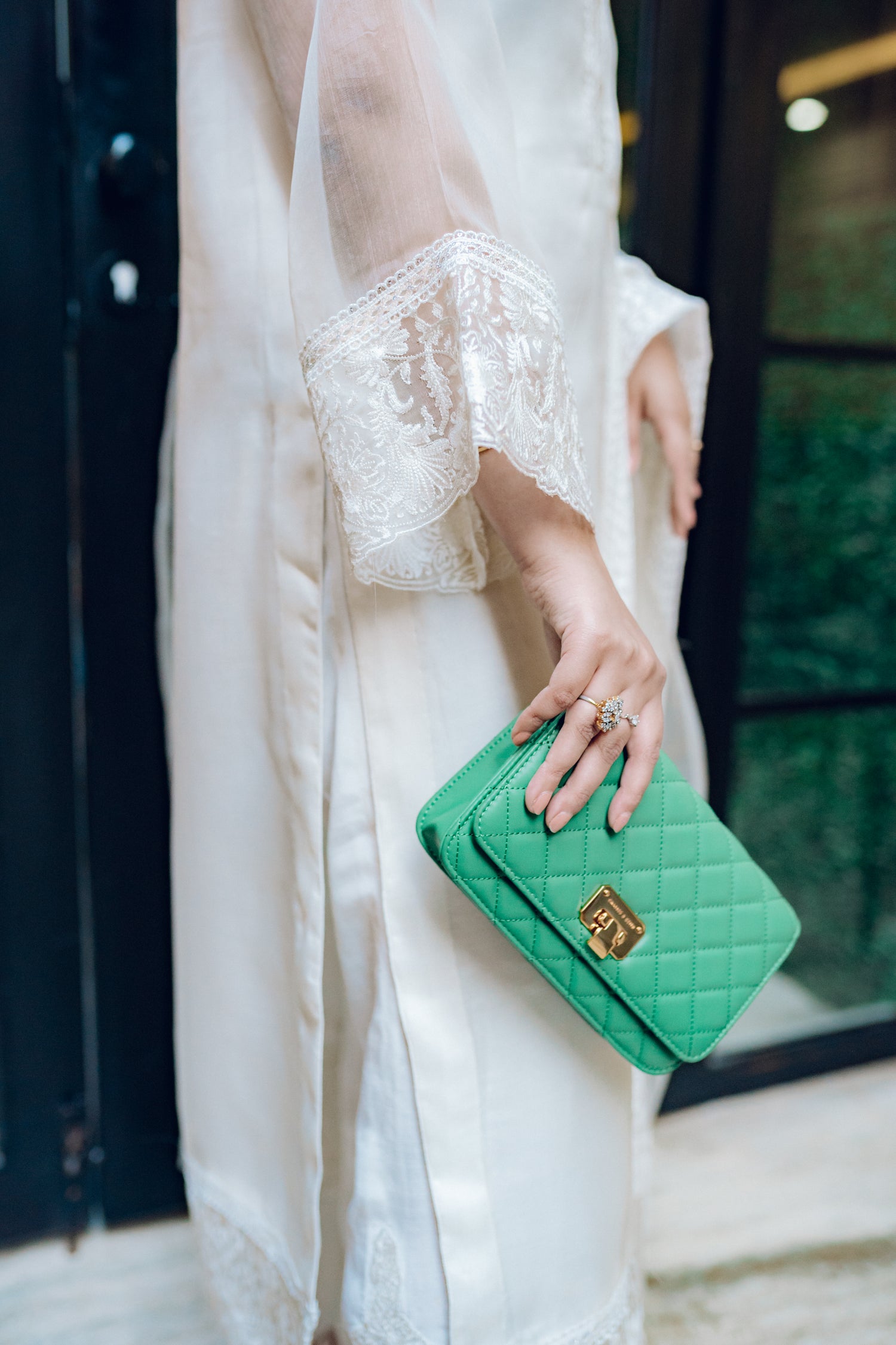 A white dress featuring intricate lace and embroidered organza, exuding elegance and sophistication.