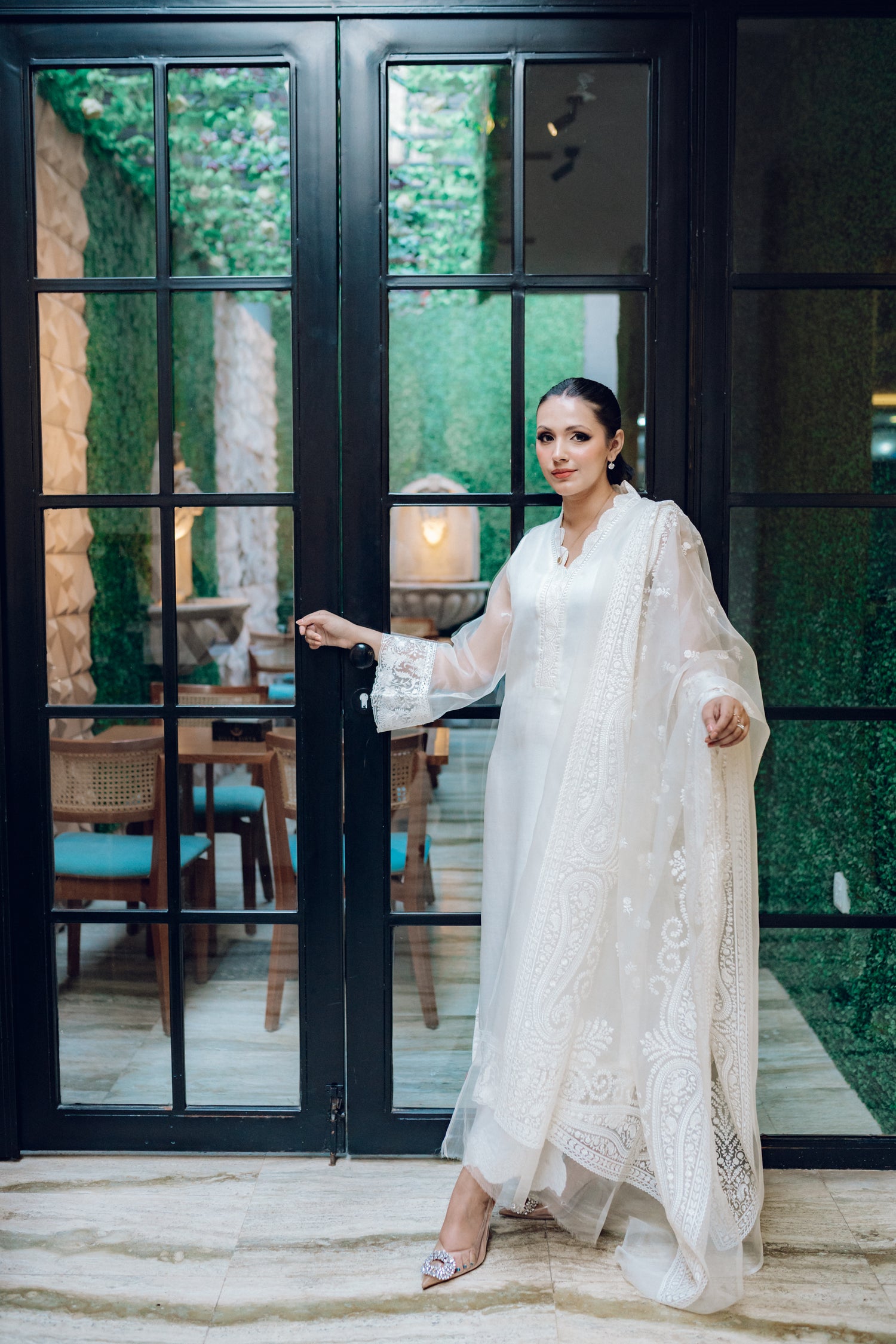A white dress featuring intricate lace and embroidered organza, exuding elegance and sophistication.