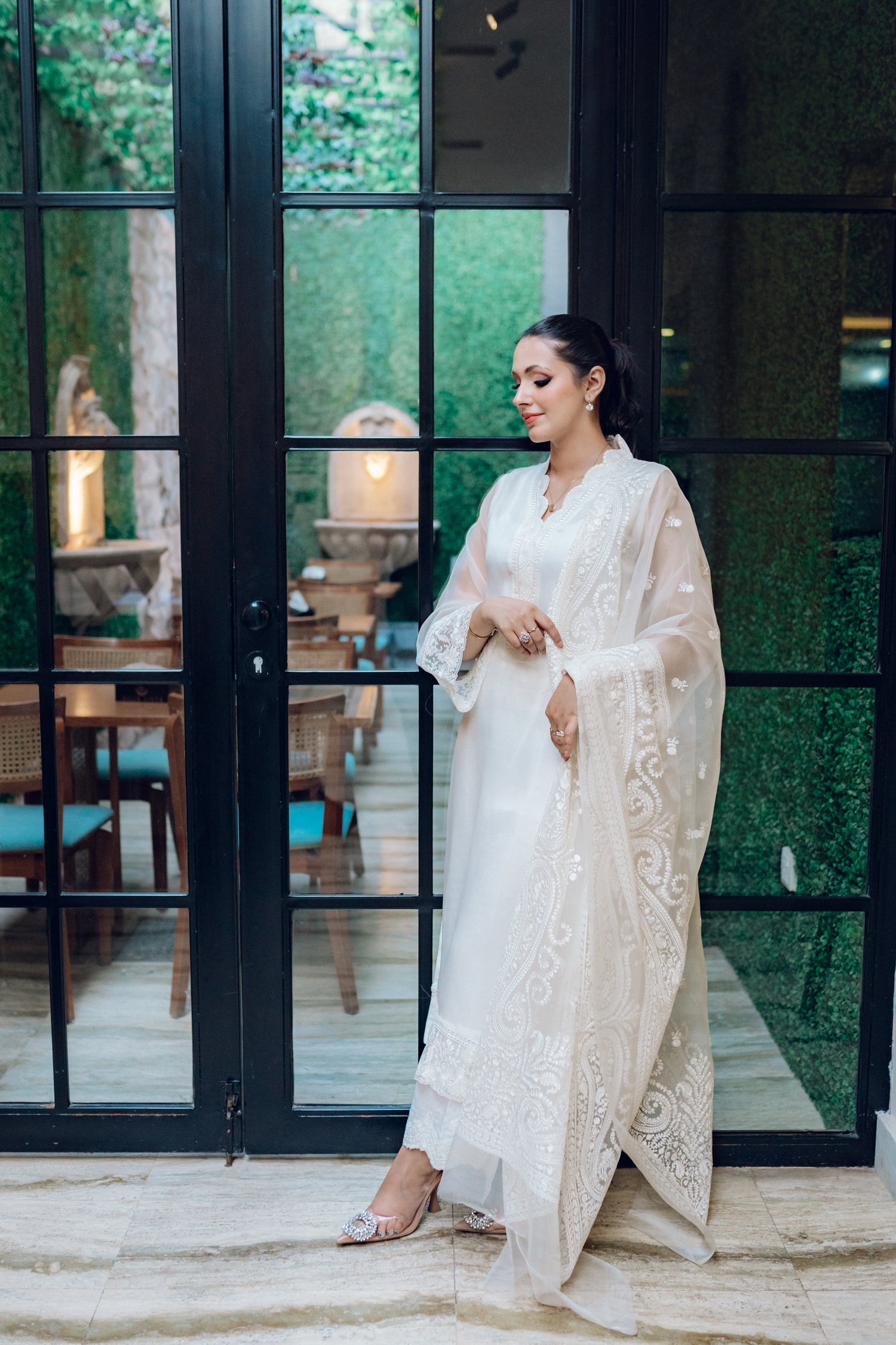 A white dress featuring intricate lace and embroidered organza, exuding elegance and sophistication.