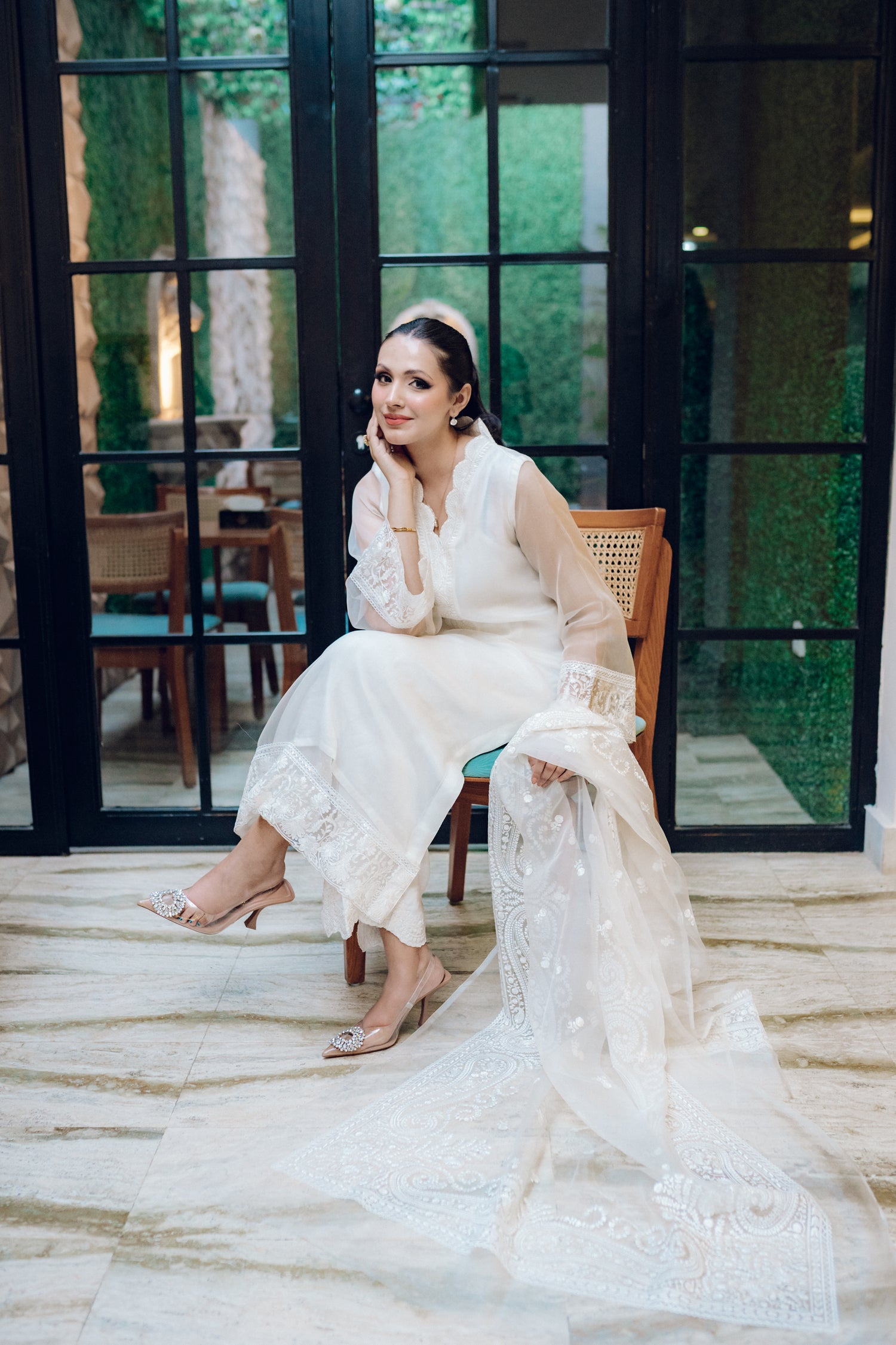 A white dress featuring intricate lace and embroidered organza, exuding elegance and sophistication.