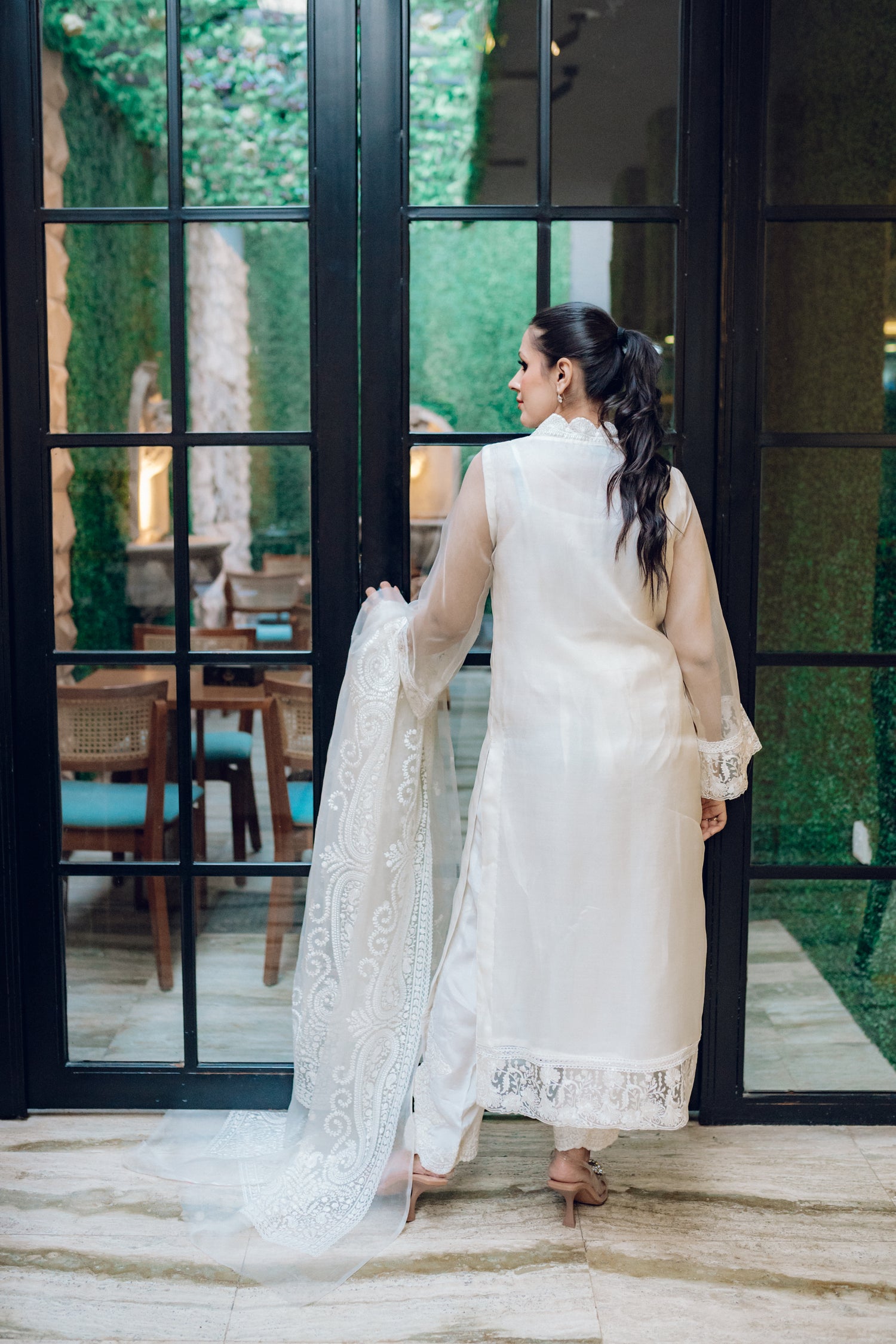 A white dress featuring intricate lace and embroidered organza, exuding elegance and sophistication.