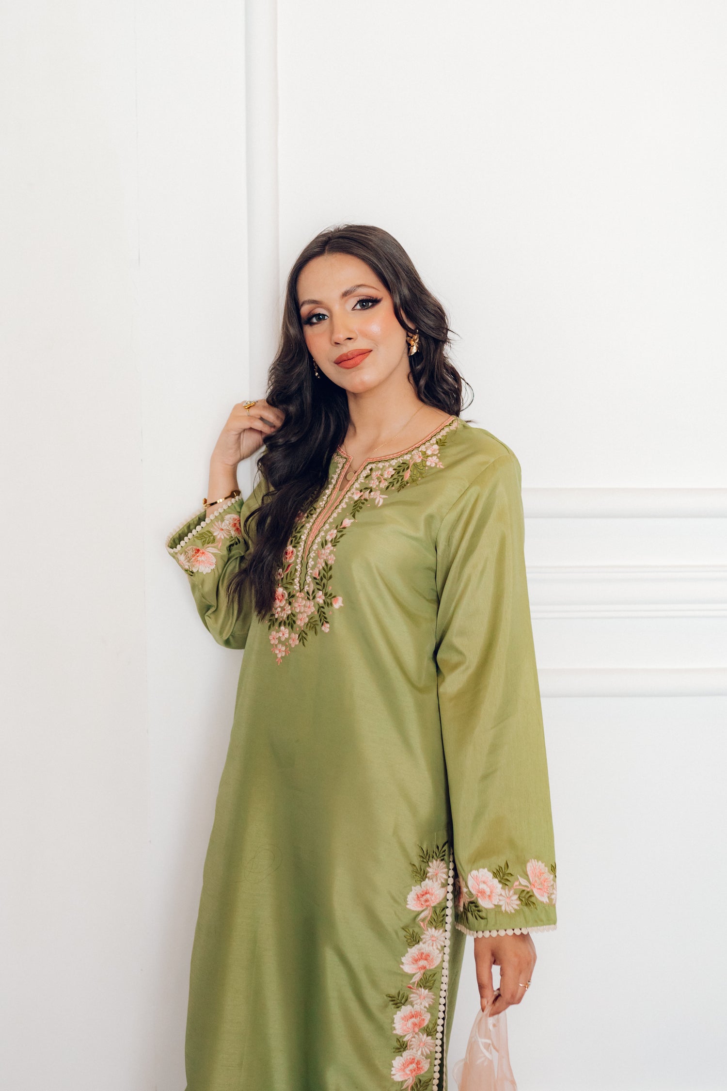 Vibrant leaf green colored dress with floral embroidery, paired with a peach pink cutwork dupatta, capturing the essence of spring with nature-inspired elegance and graceful charm.