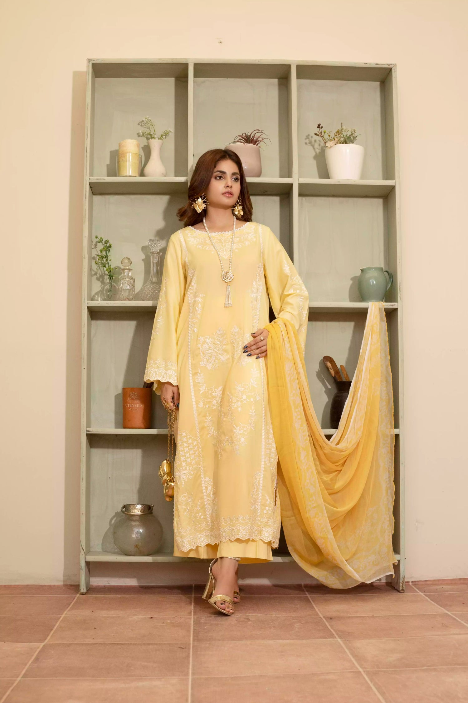 Stunning yellow embroidered suit, featuring intricate white embroidery, paired with matching plain pants and chiffon dupatta.