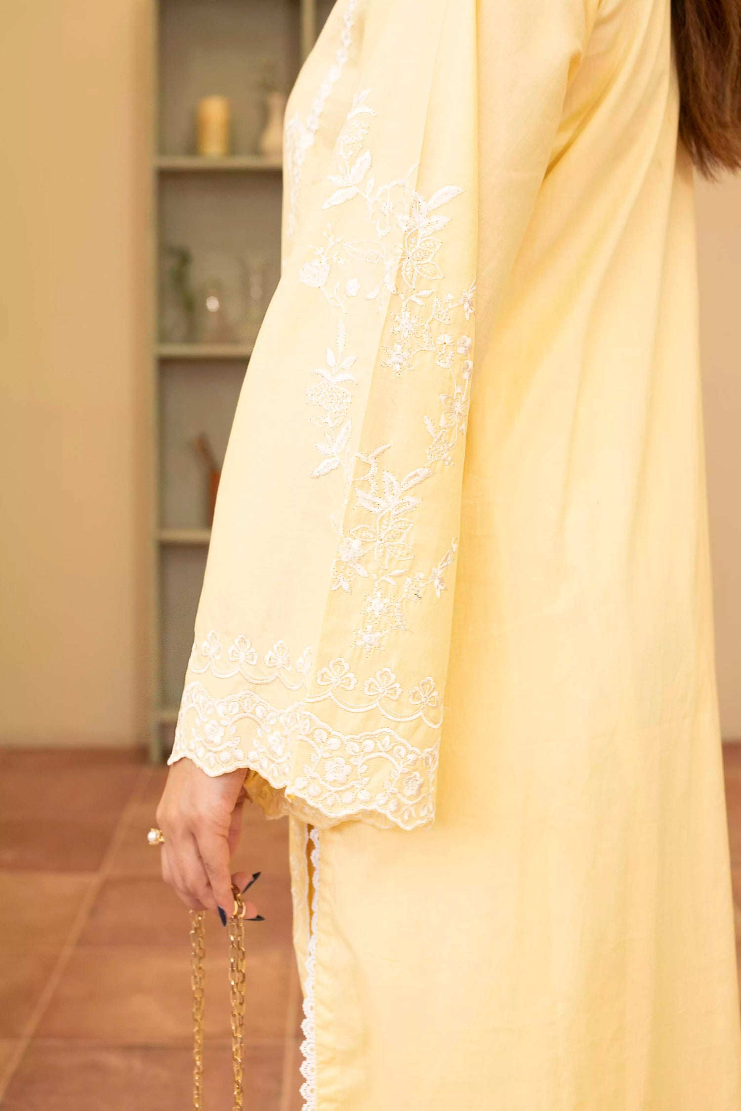 Stunning yellow embroidered suit, featuring intricate white embroidery, paired with matching plain pants and chiffon dupatta.