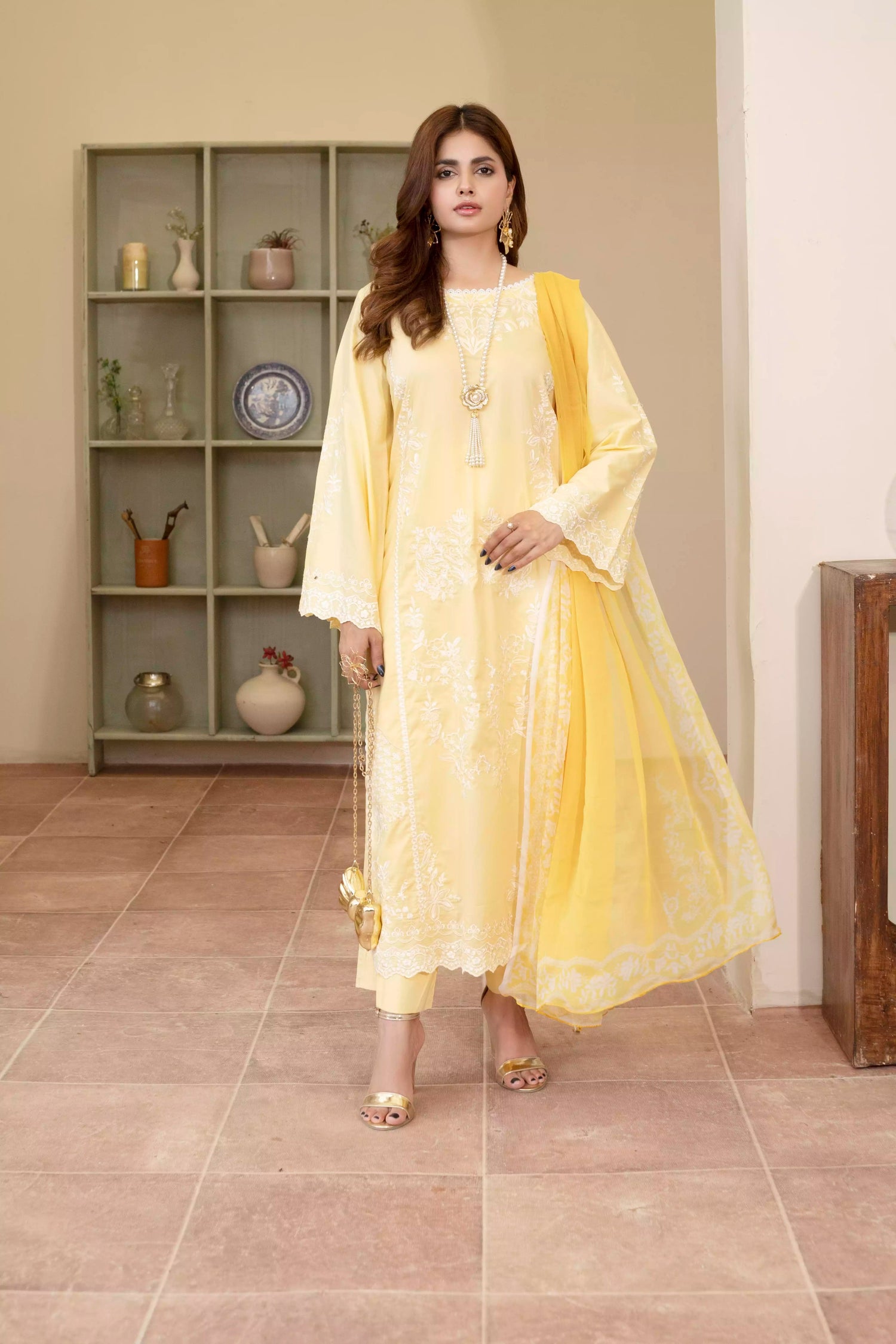 Stunning yellow embroidered suit, featuring intricate white embroidery, paired with matching plain pants and chiffon dupatta.