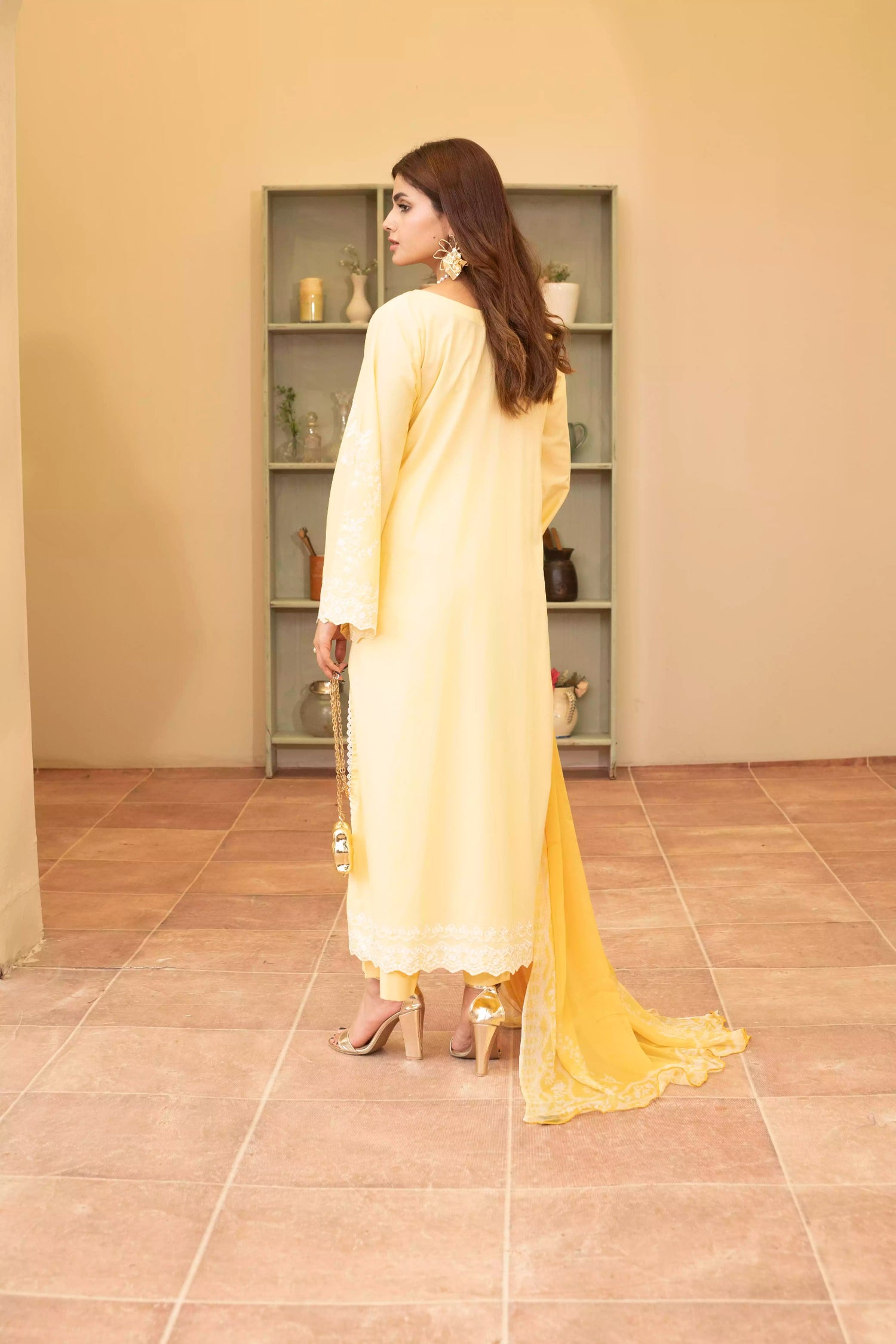 Stunning yellow embroidered suit, featuring intricate white embroidery, paired with matching plain pants and chiffon dupatta.