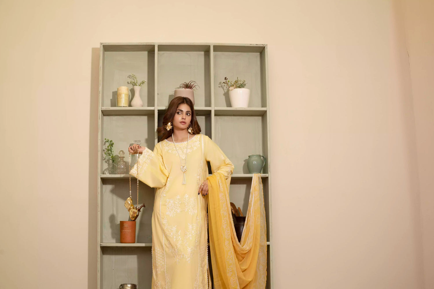 Stunning yellow embroidered suit, featuring intricate white embroidery, paired with matching plain pants and chiffon dupatta.