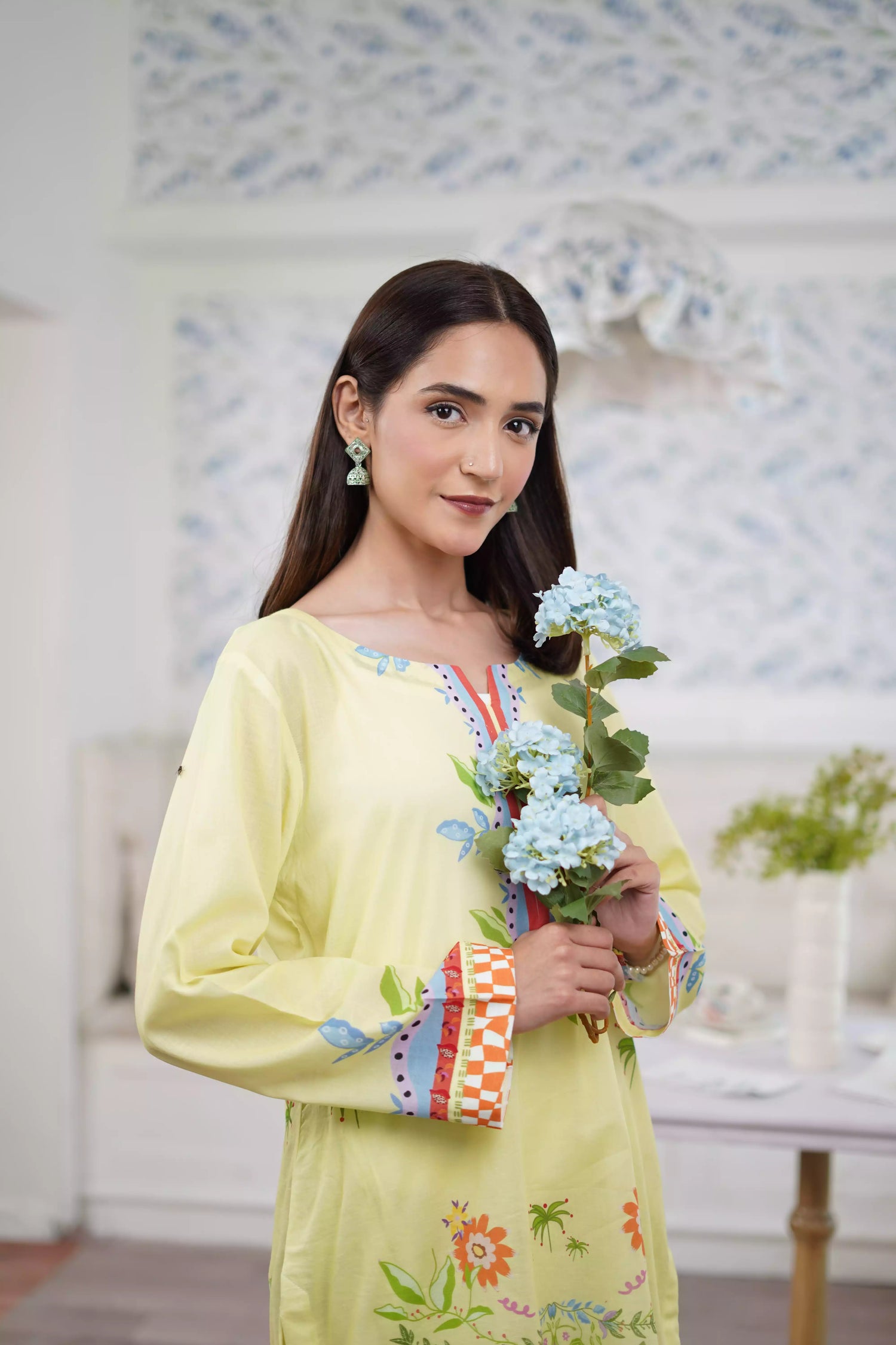 A pastel yellow digital-printed 2 piece suit adorned with calming blues, delicate florals. A perfect blend of simplicity and charm.