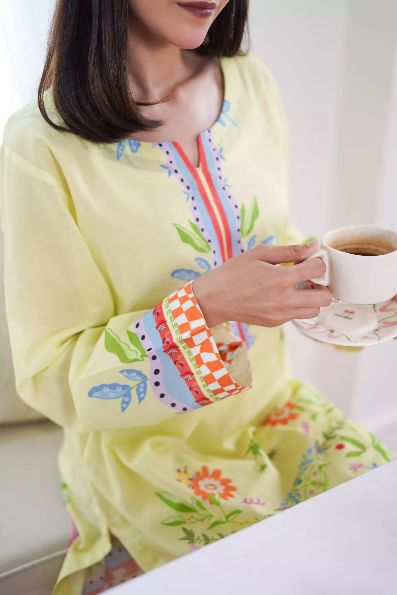 A pastel yellow digital-printed 2 piece suit adorned with calming blues, delicate florals. A perfect blend of simplicity and charm.