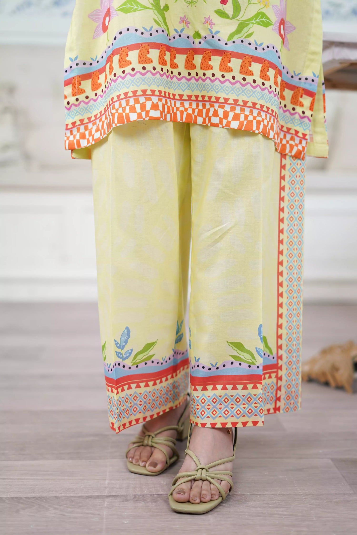 A pastel yellow digital-printed 2 piece suit adorned with calming blues, delicate florals. A perfect blend of simplicity and charm.