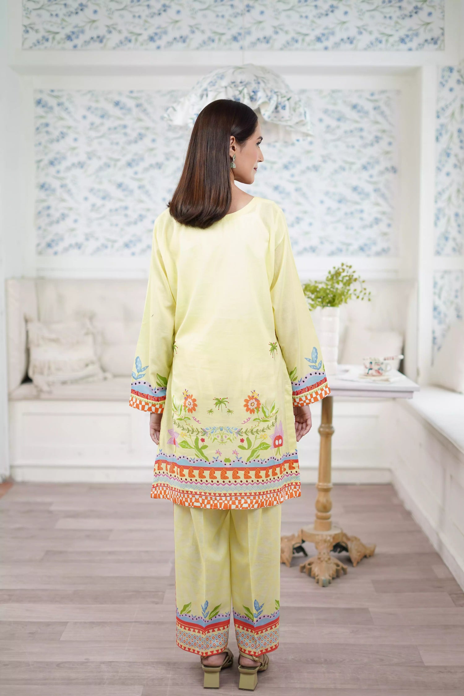 A pastel yellow digital-printed 2 piece suit adorned with calming blues, delicate florals. A perfect blend of simplicity and charm.