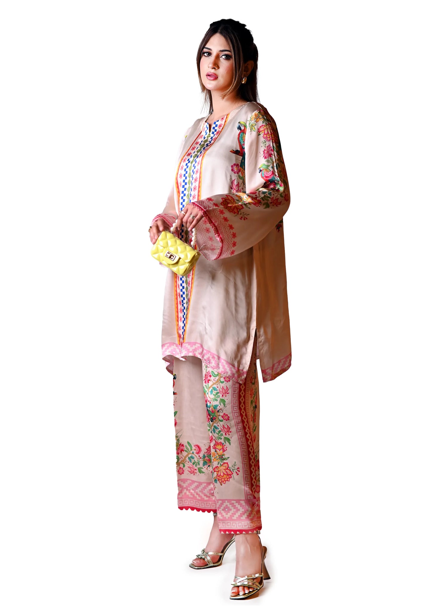 A printed silk cord set in beige featuring vibrant floral and parrot motifs, crafted from luxurious silk for a soft, elegant drape.