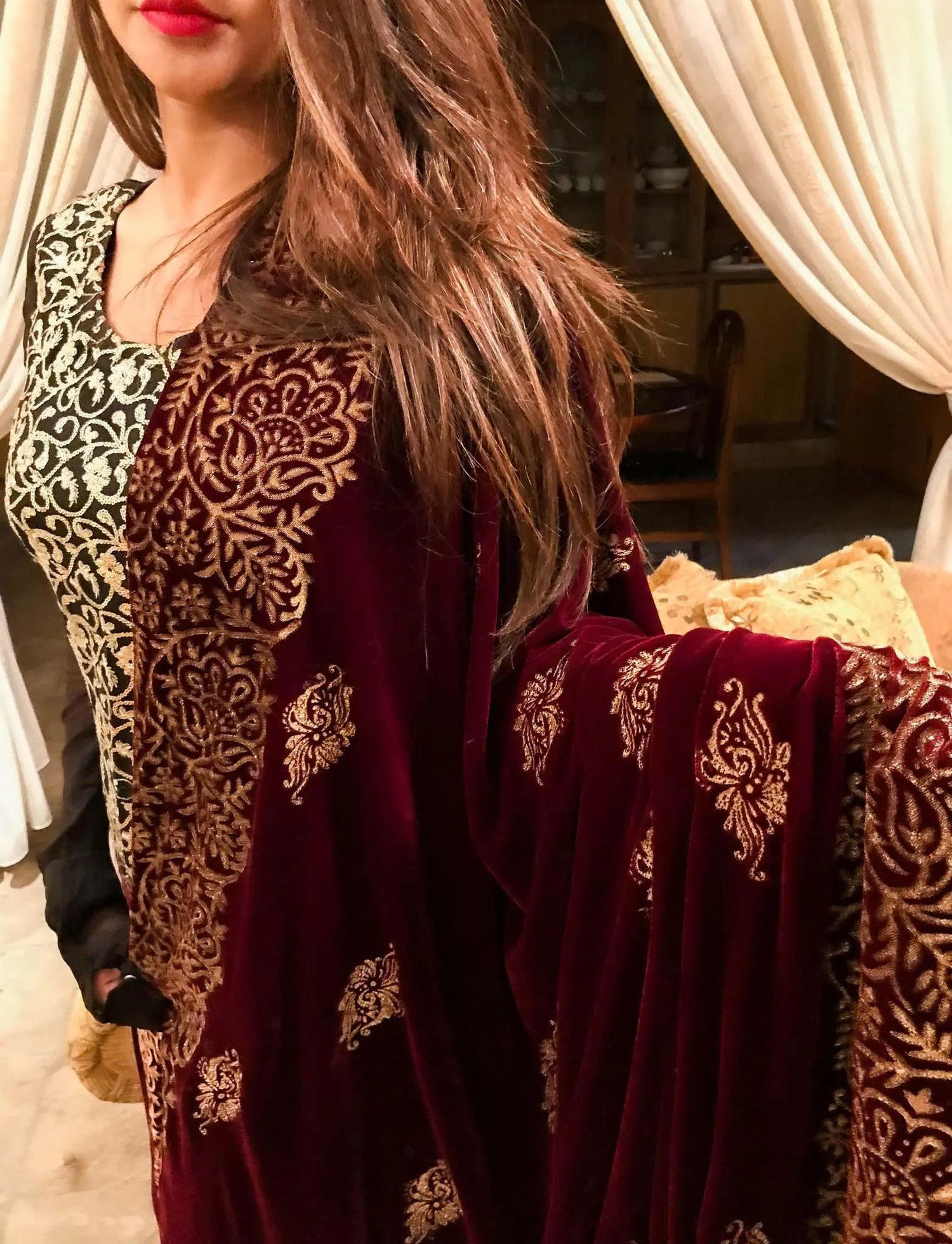 Maroon velvet shawl with an embroidered gold block printed border, featuring screen printed floral motifs showcasing traditional craftsmanship.