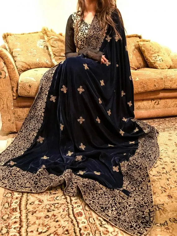 A luxurious velvet shawl with intricate geometric motifs first designed with block print and then outlined with shimmering golden accents.